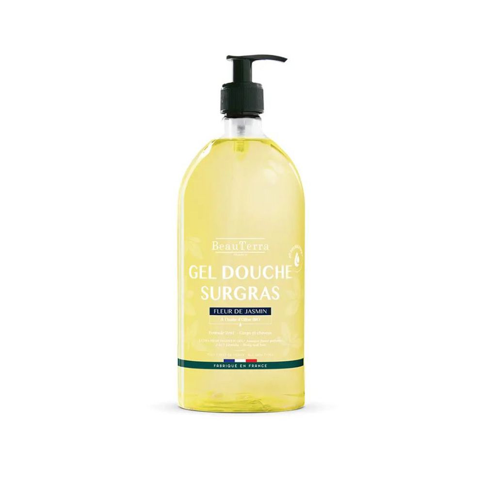 Klare Flasche mit gelbem Duschgel. Schwarzer Pumpspender. Etikett mit Text: Gel Douche Surgras, Parfum Fleur de Jasmin. Französische Flagge.