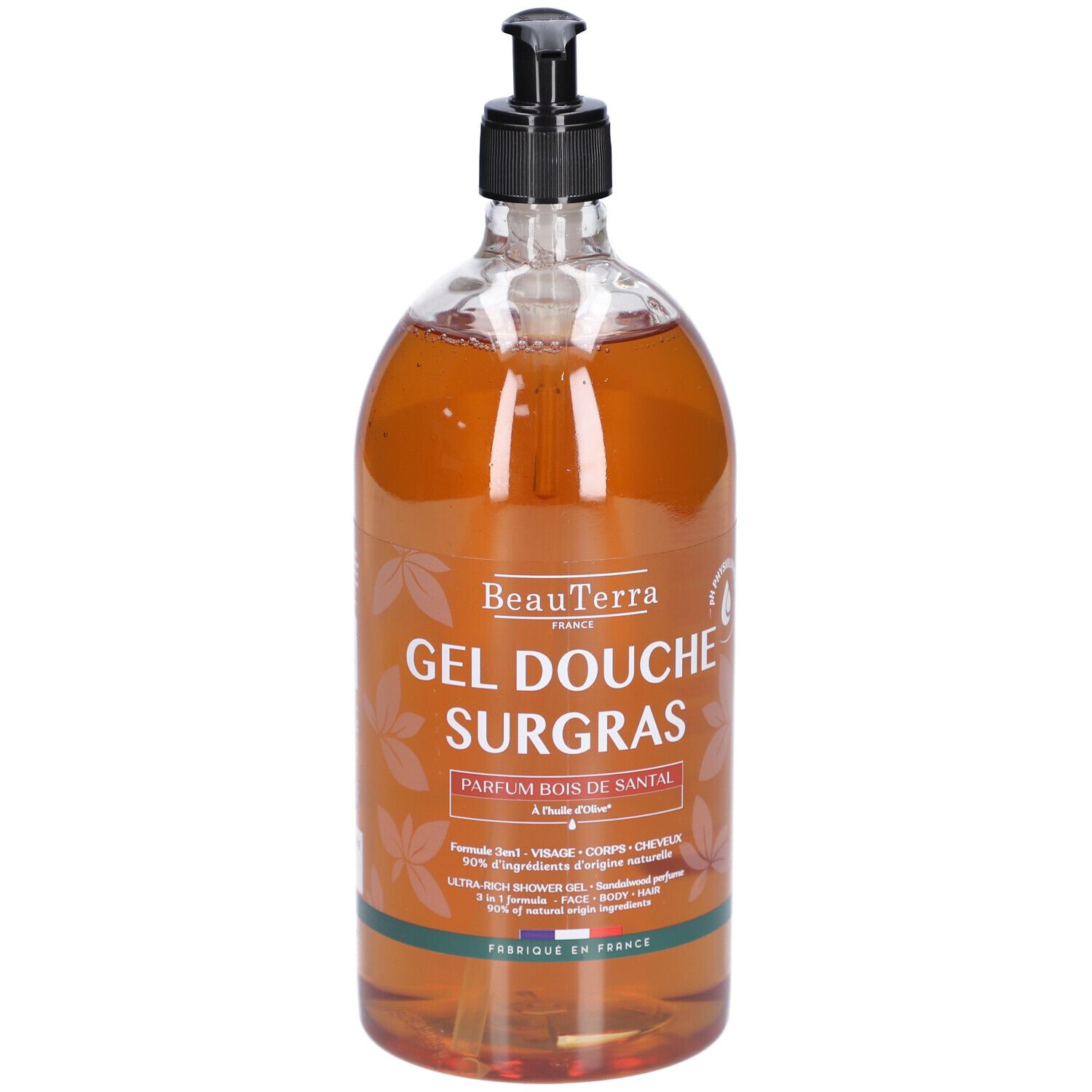 Transparente Flasche mit braunem Duschgel. Schwarzer Spender. Aufschrift: Gel Douche Surgras, Parfum Bois de Santal.