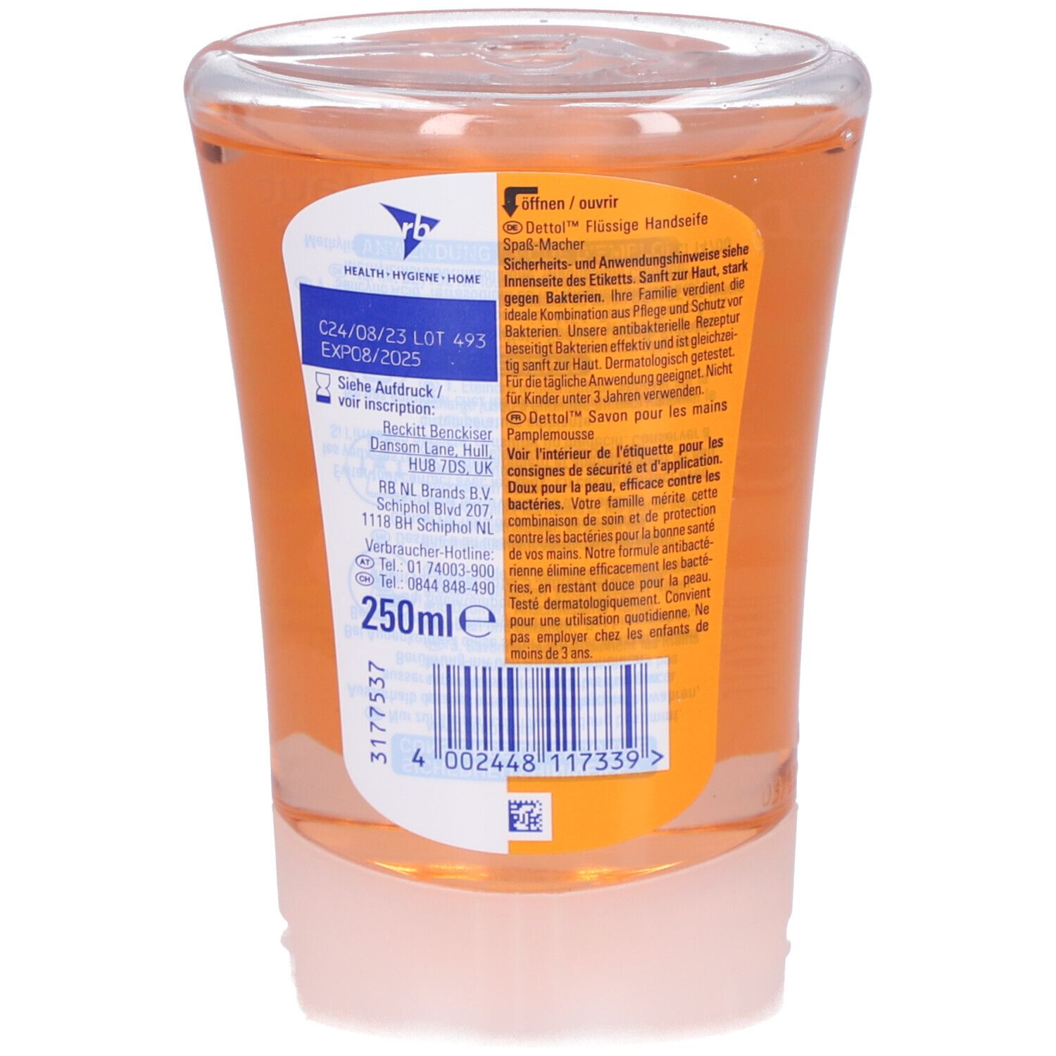Dos d'un récipient transparent avec liquide orange. Étiquette avec texte et code-barres.