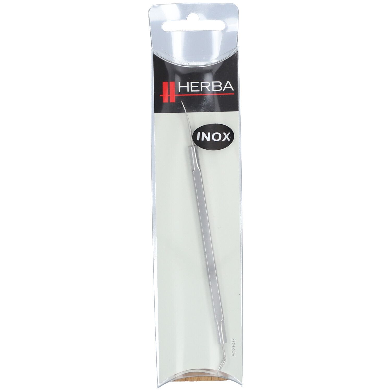 HERBA Inox tire-comédons dans emballage. Acier inoxydable, long, avec boucle et pointe. Texte noir.