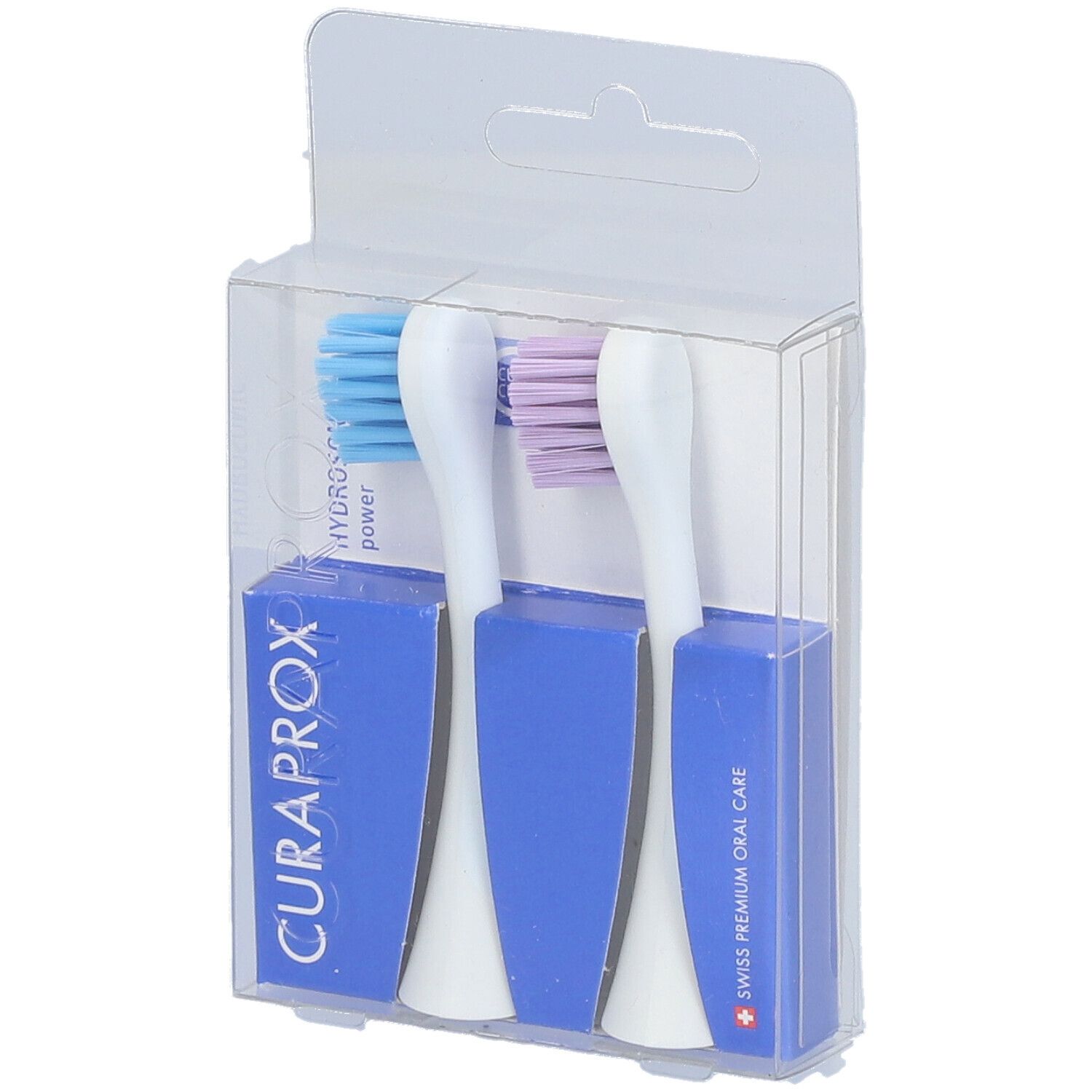 Zwei Zahnbürstenköpfe in einer transparenten Verpackung. Blaue und lila Borsten, weißer Griff, blaue Halterung.