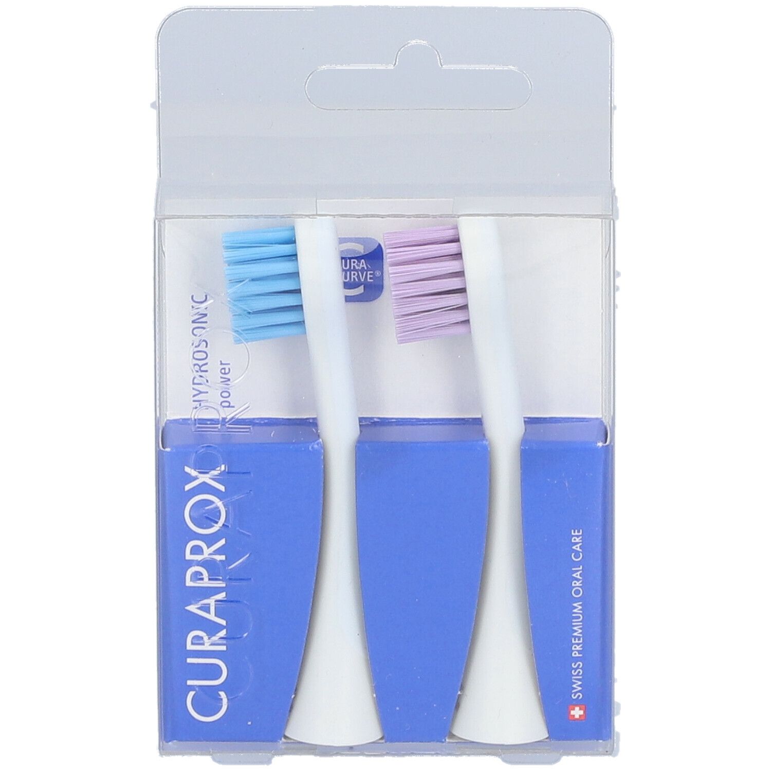 Zwei Zahnbürstenköpfe in Verpackung. Blaue und lila Borsten, weißer Griff, blaue Halterung, CURAPROX-Logo.