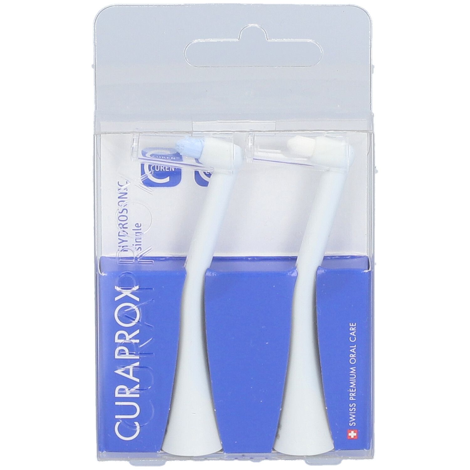 Zwei weiße Bürstenköpfe in transparenter Verpackung. Blaue Kartons mit CURAPROX-Logo und Text.