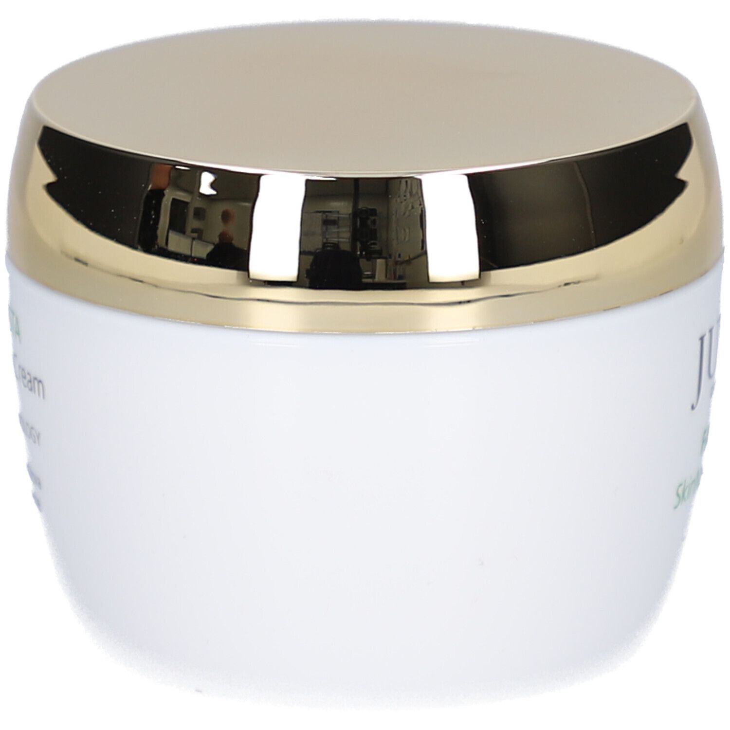 Weißer Tiegel mit goldenem Deckel. Aufschrift nicht sichtbar.