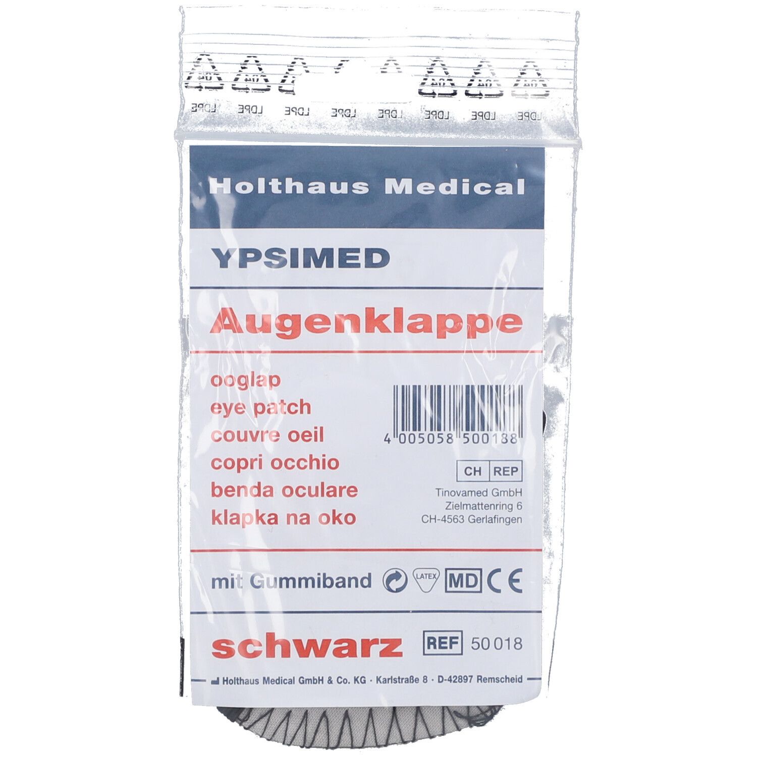 Augenklappe in Verpackung. Schwarzes Produkt mit Gummiband. Text: YPSIMED, Augenklappe, Holthaus Medical. CE-Kennzeichnung.