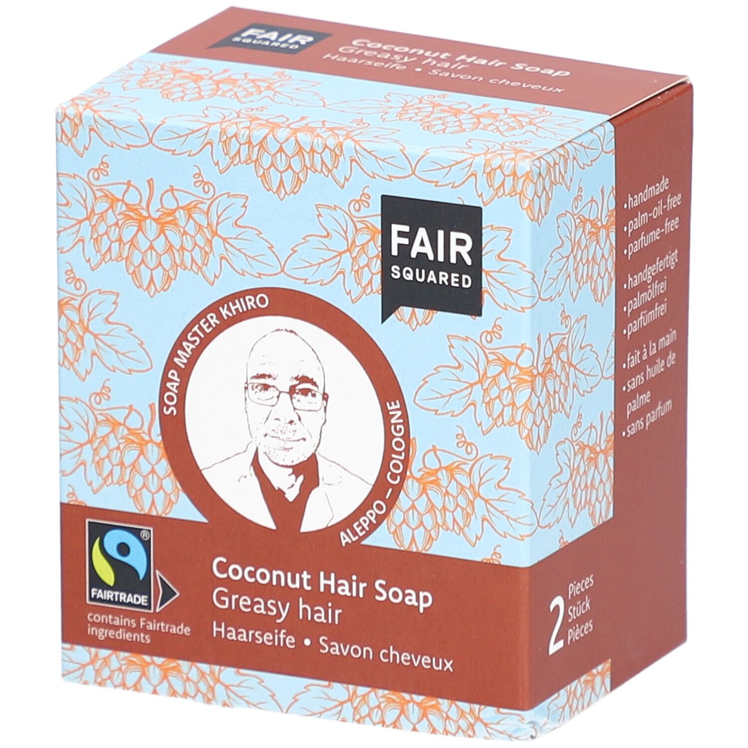 Karton mit FAIR SQUARED Haarseife Coco. Aufdruck: FAIR SQUARED, Fairtrade-Siegel, Soap Master Khiro, Kokosnuss Haarseife, 2 Stück.