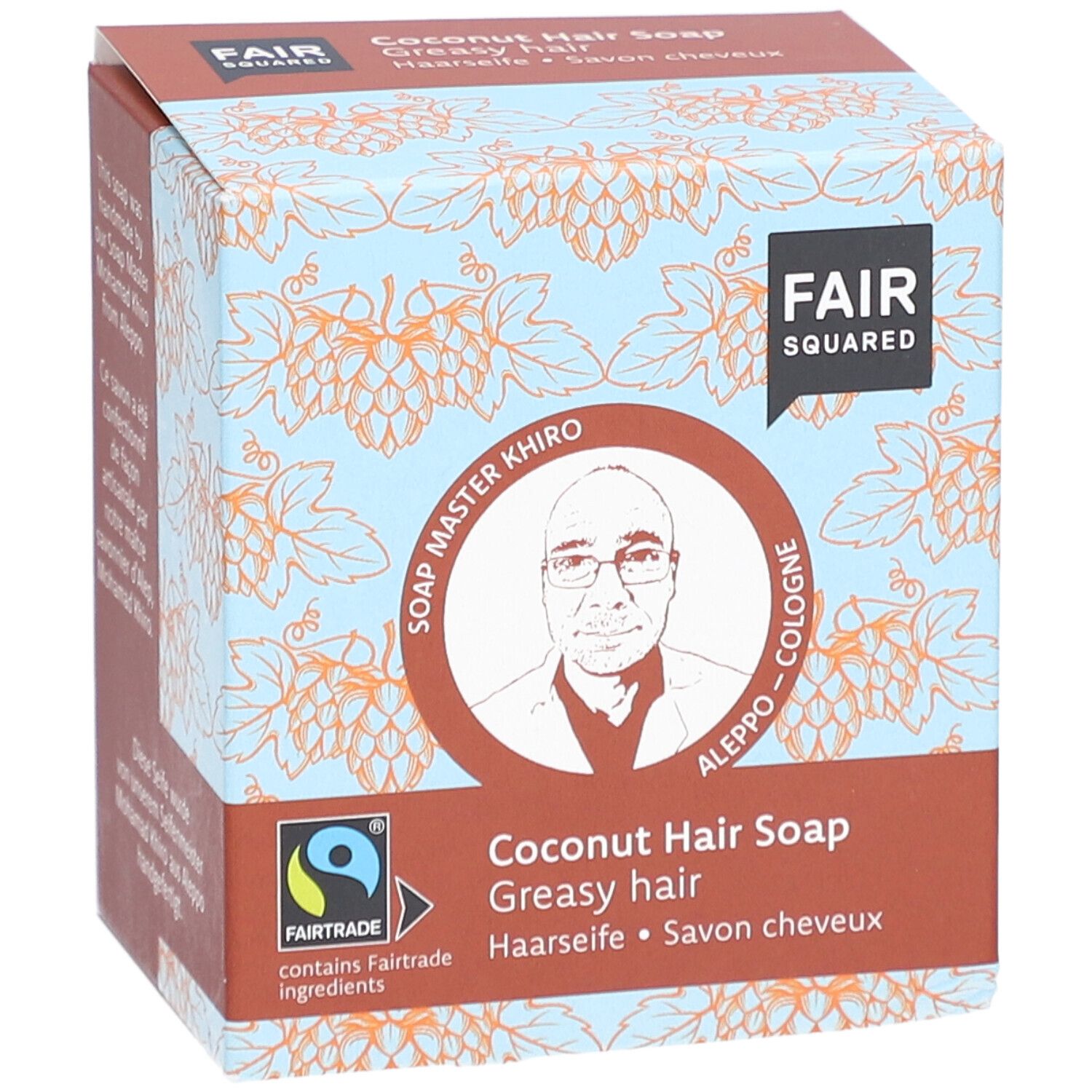 Karton mit FAIR SQUARED Haarseife Coco. Aufdruck: FAIR SQUARED, Soap Master Khiro, Fairtrade-Siegel, Kokosnuss Haarseife, für fettiges Haar.
