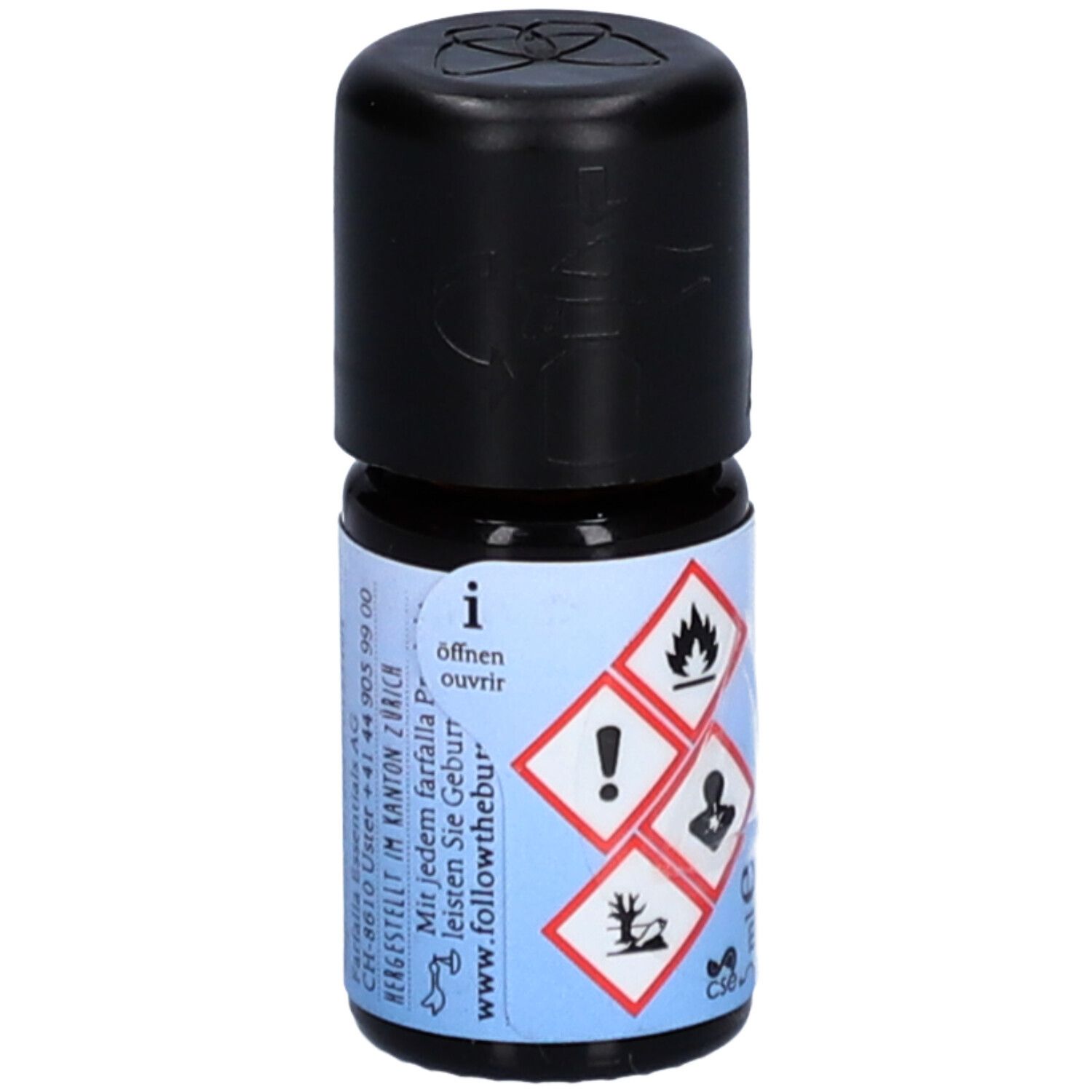 Kleine Glasflasche mit schwarzem Deckel. Etikett mit Gefahrensymbolen und Text: Öffnen, followthebur.