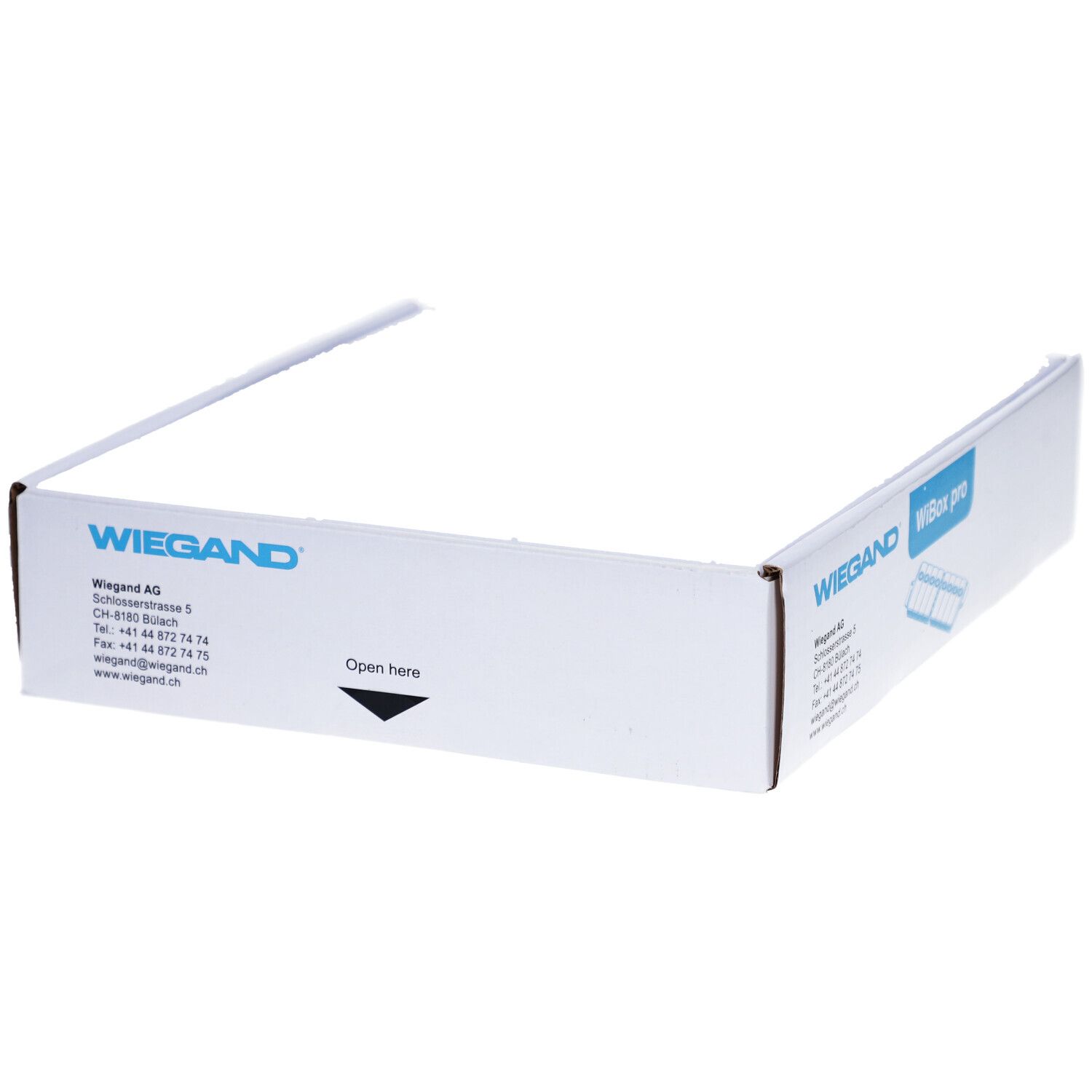 Emballage blanc ouvert avec impression WIEGAND. Flèche avec indication 'Open here'.