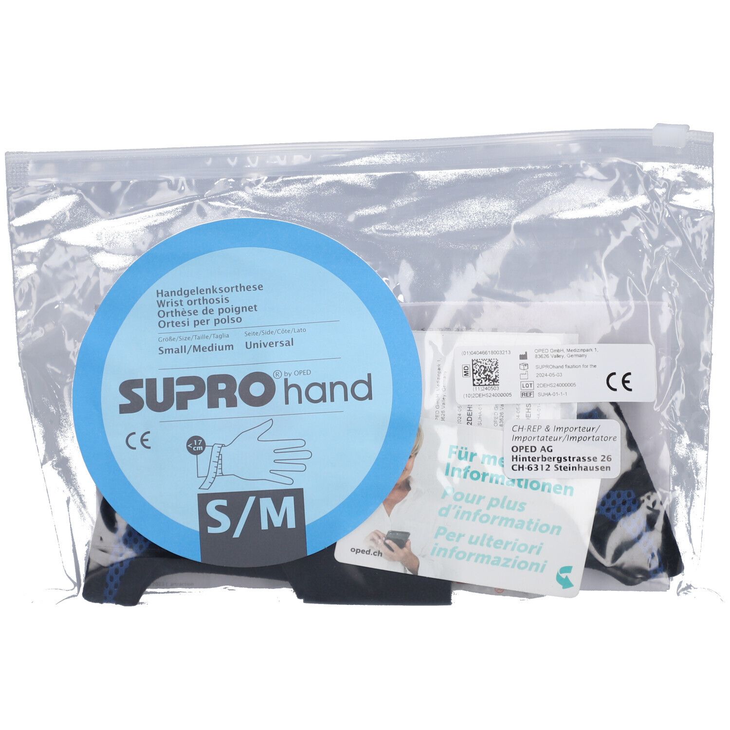 Handgelenkorthese SUPROhand in Plastikverpackung. Blaue runde Karte mit Produktinformationen und CE-Zeichen.