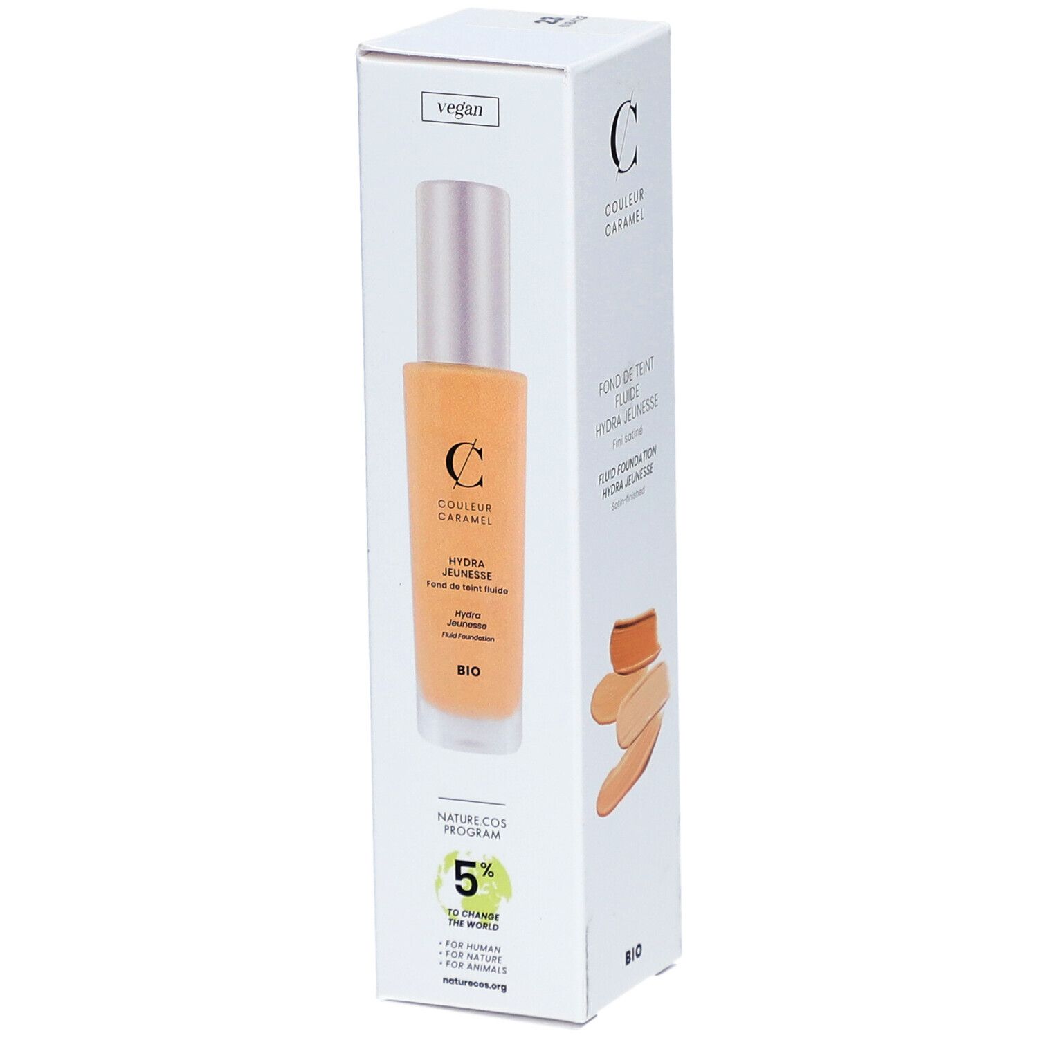 Weiße Verpackung mit Produkt und Farbmuster. "COULEUR CARAMEL" und "FOND DE TEINT FLUIDE HYDRA JEUNESSE". Vegan-Logo.
