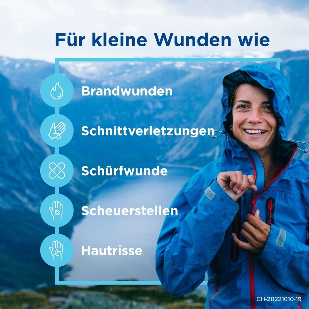Frau in blauer Jacke vor Berglandschaft. Text: Für kleine Wunden wie Brandwunden, Schnittverletzungen, Schürfwunden, Scheuerstellen, Hautrisse.