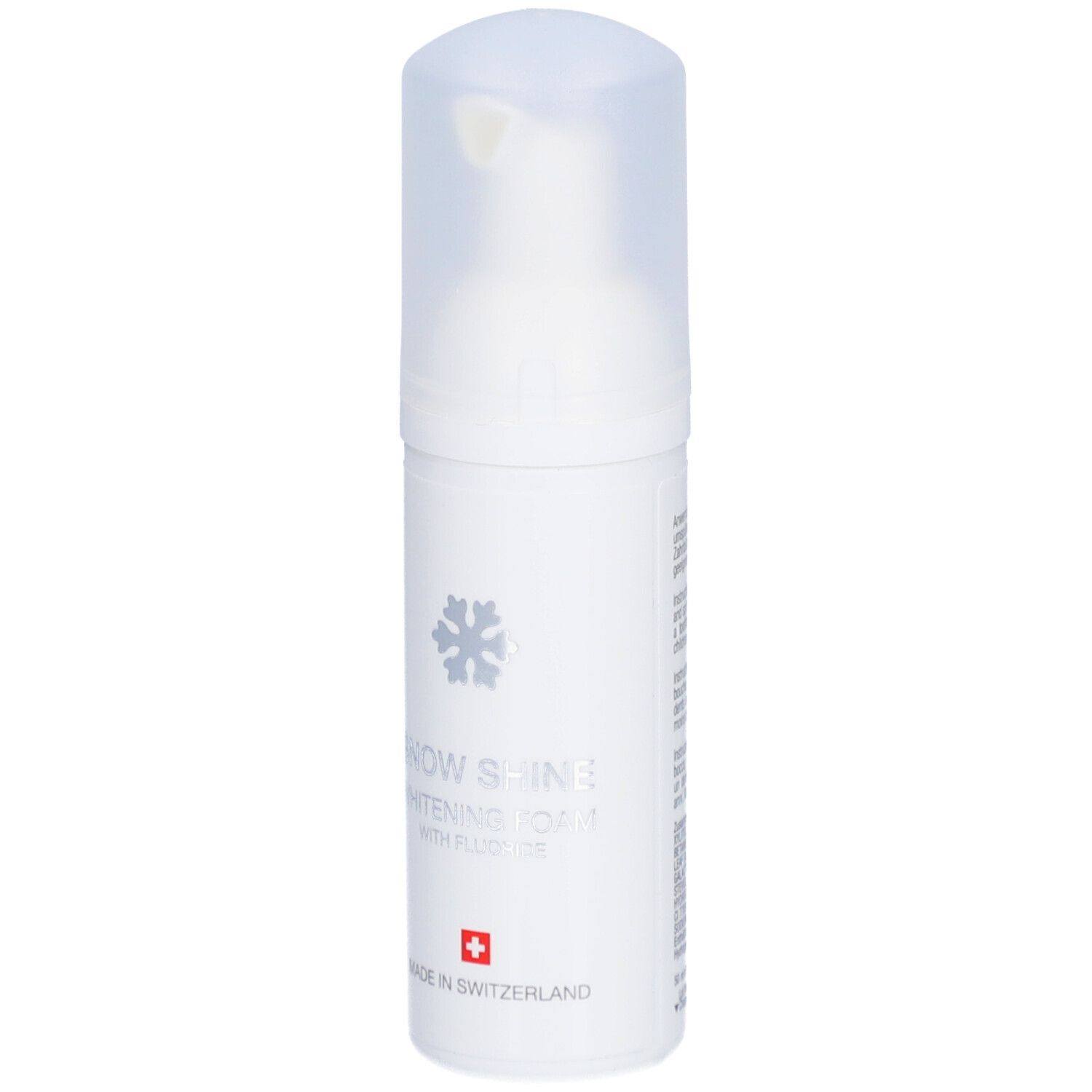 Weiße Flasche mit Schaum. Aufschrift: Snow Shine Whitening Foam mit Fluorid. Schweizer Kreuz.