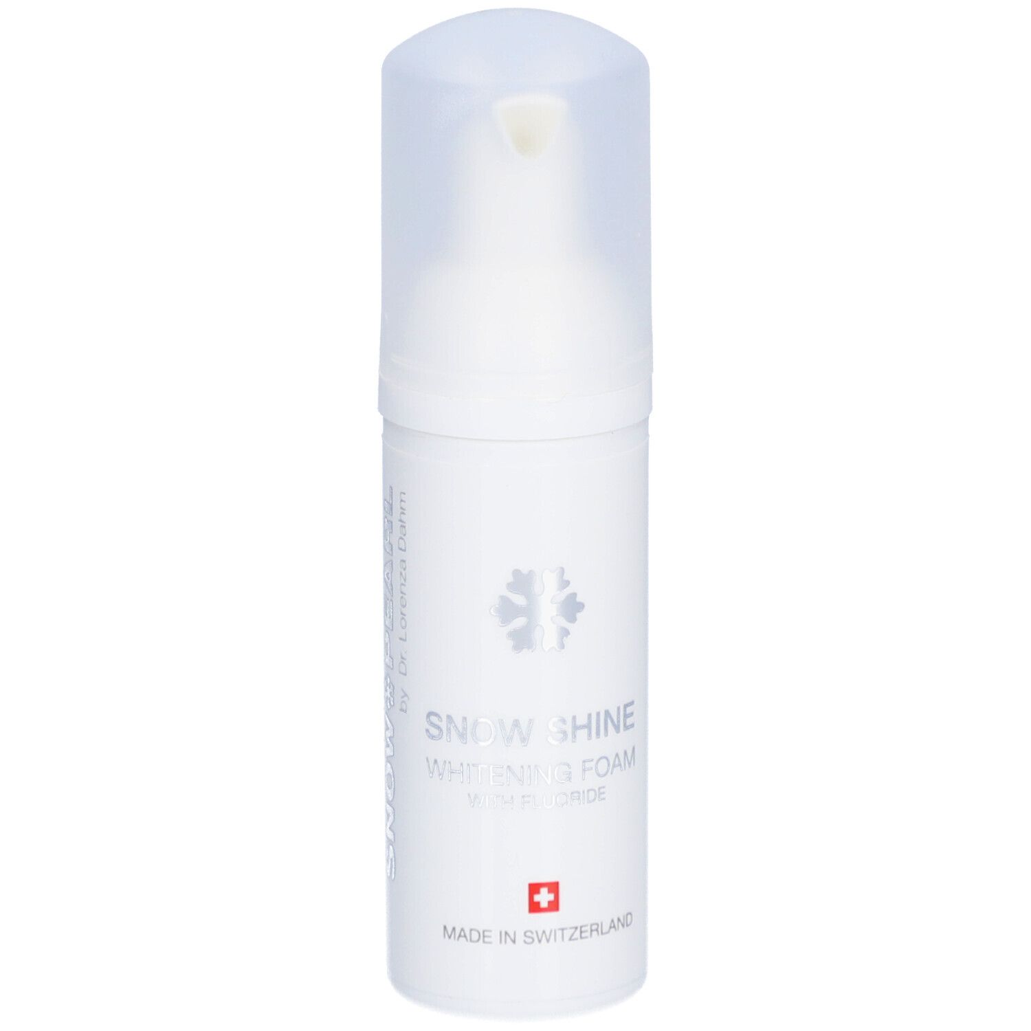 Weiße Flasche mit Schaum. Aufschrift: Snow Shine Whitening Foam mit Fluorid. Schweizer Kreuz.