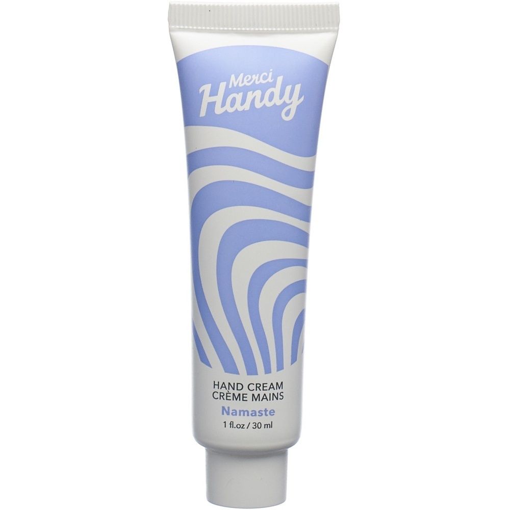 Tube de crème pour les mains avec motif ondulé bleu et blanc. Inscription "Merci Handy" et "Hand Cream Namaste". 1 fl.oz / 30 ml.