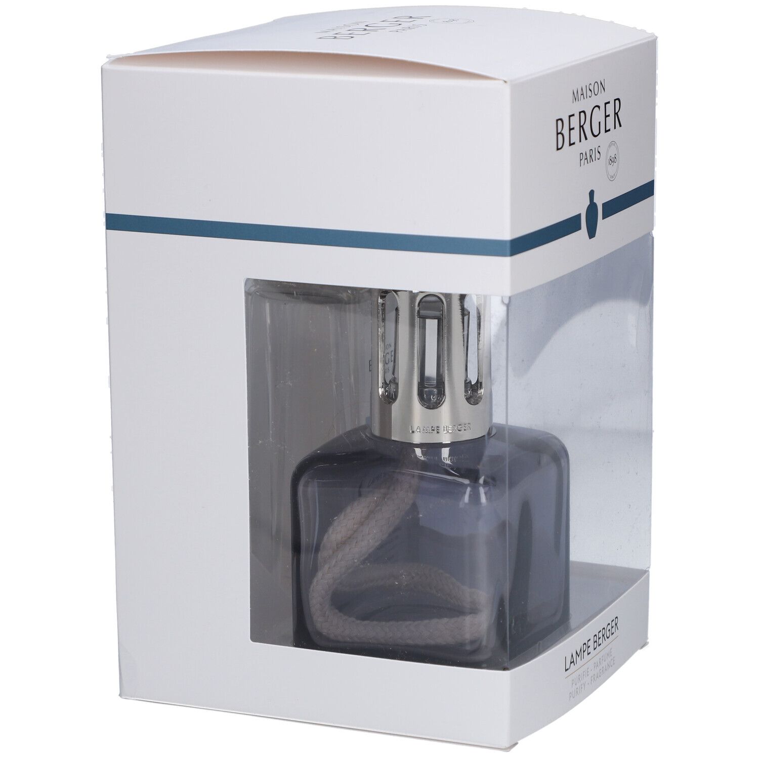Duftlampe in Verpackung. Graue, eckige Lampe mit Docht. Verpackung weiß mit transparentem Fenster.