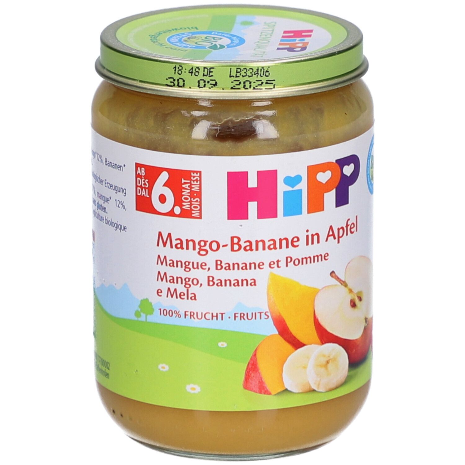 Pot de purée HiPP Bio Mangue-Banane-Pomme. Étiquette avec nom du produit, illustrations de fruits et label bio. Couvercle avec date de péremption.