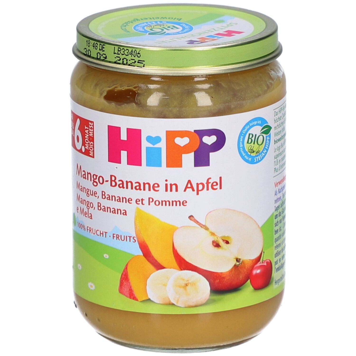 Pot de purée HiPP Bio Mangue-Banane-Pomme. Étiquette avec nom du produit, illustrations de fruits et label bio. Couvercle avec date de péremption.