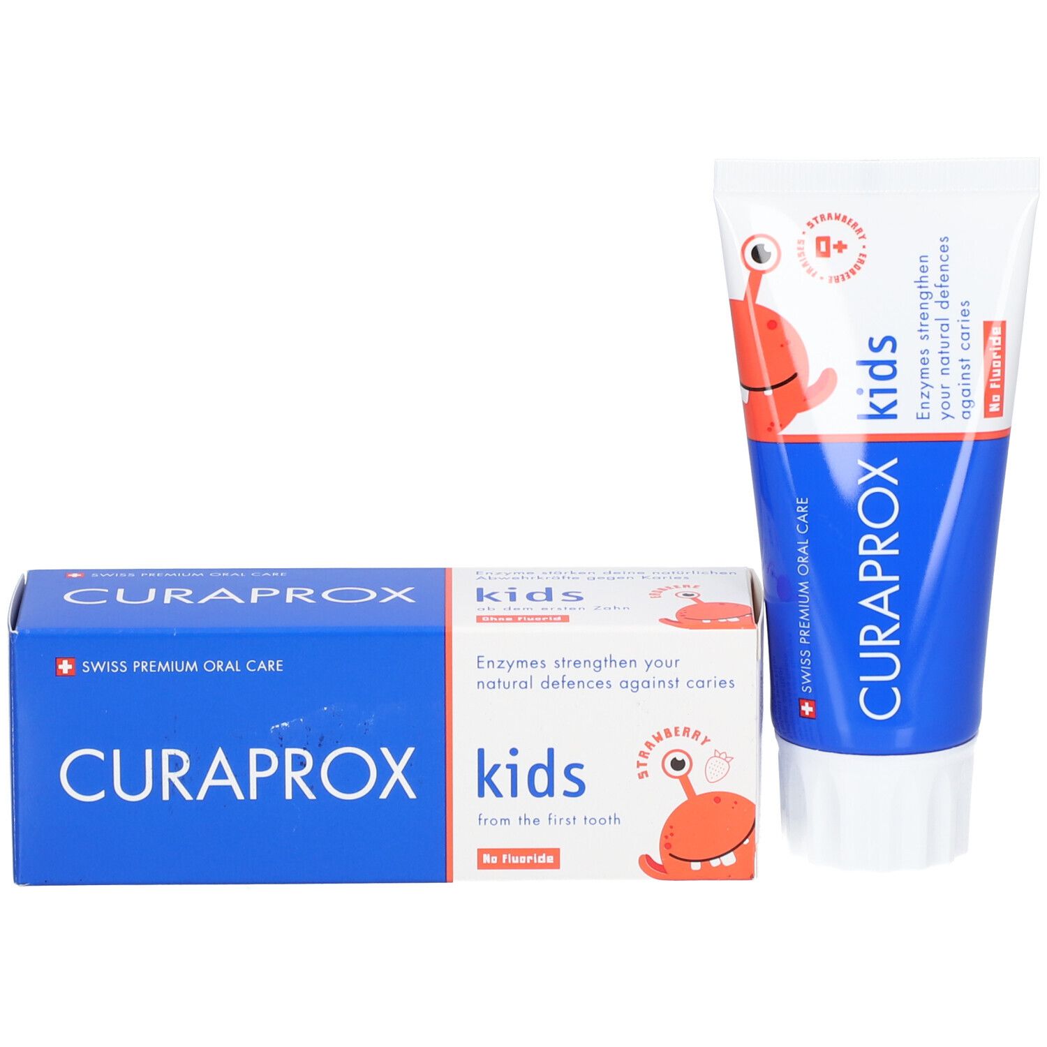 Zahncreme-Tube und zwei Schachteln. Aufschrift: CURAPROX, kids, Erdbeergeschmack, ohne Fluorid. Mit Cartoon-Figur.