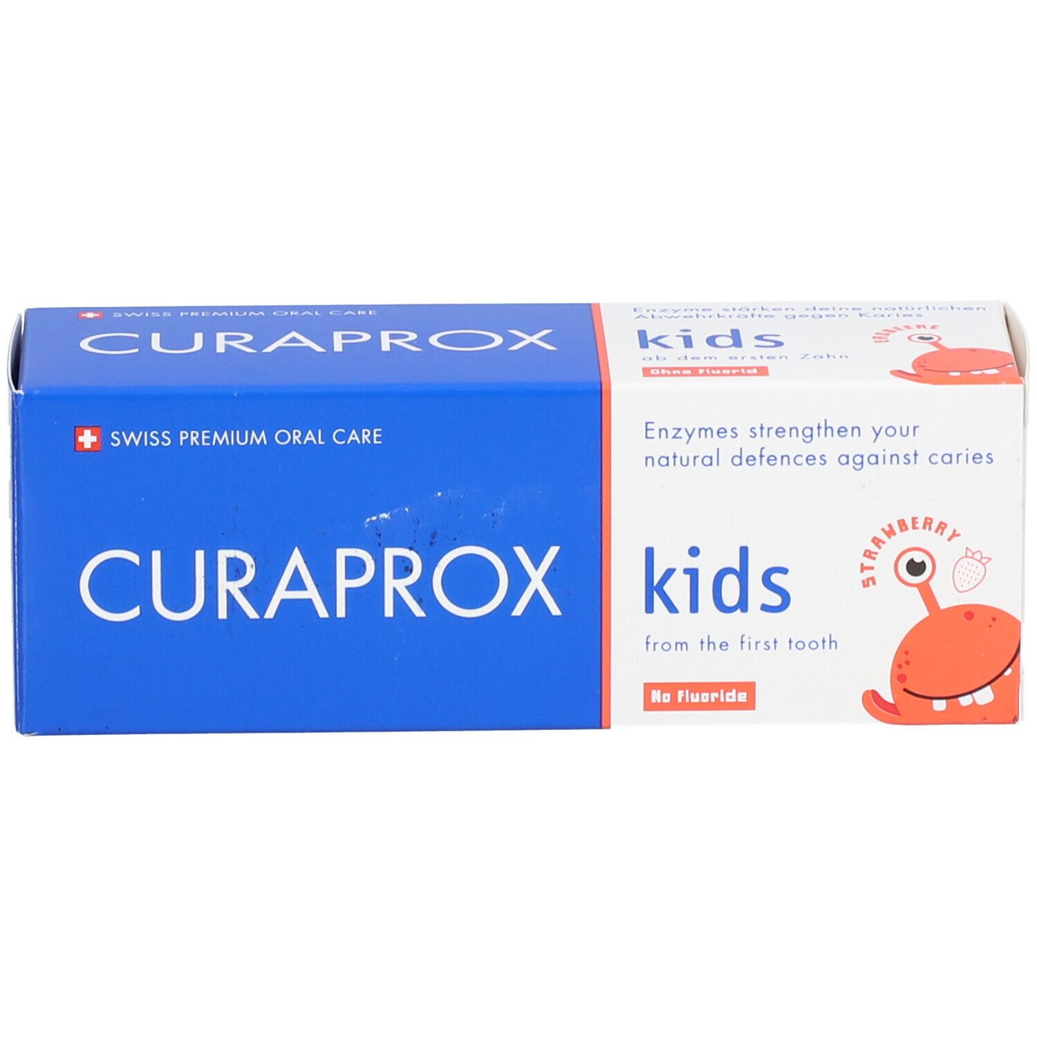 Zahncreme-Schachtel, blau-weiß. Aufschrift: CURAPROX, kids, Erdbeergeschmack, ohne Fluorid. Mit Cartoon-Figur.