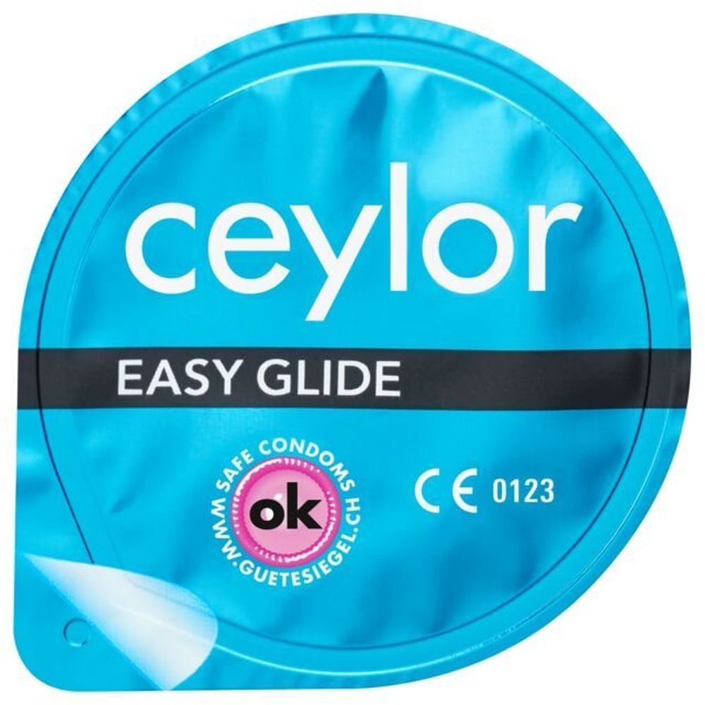 Emballage rond et bleu de préservatif. Nom et logo du produit clairement visibles. Avec marquage CE.