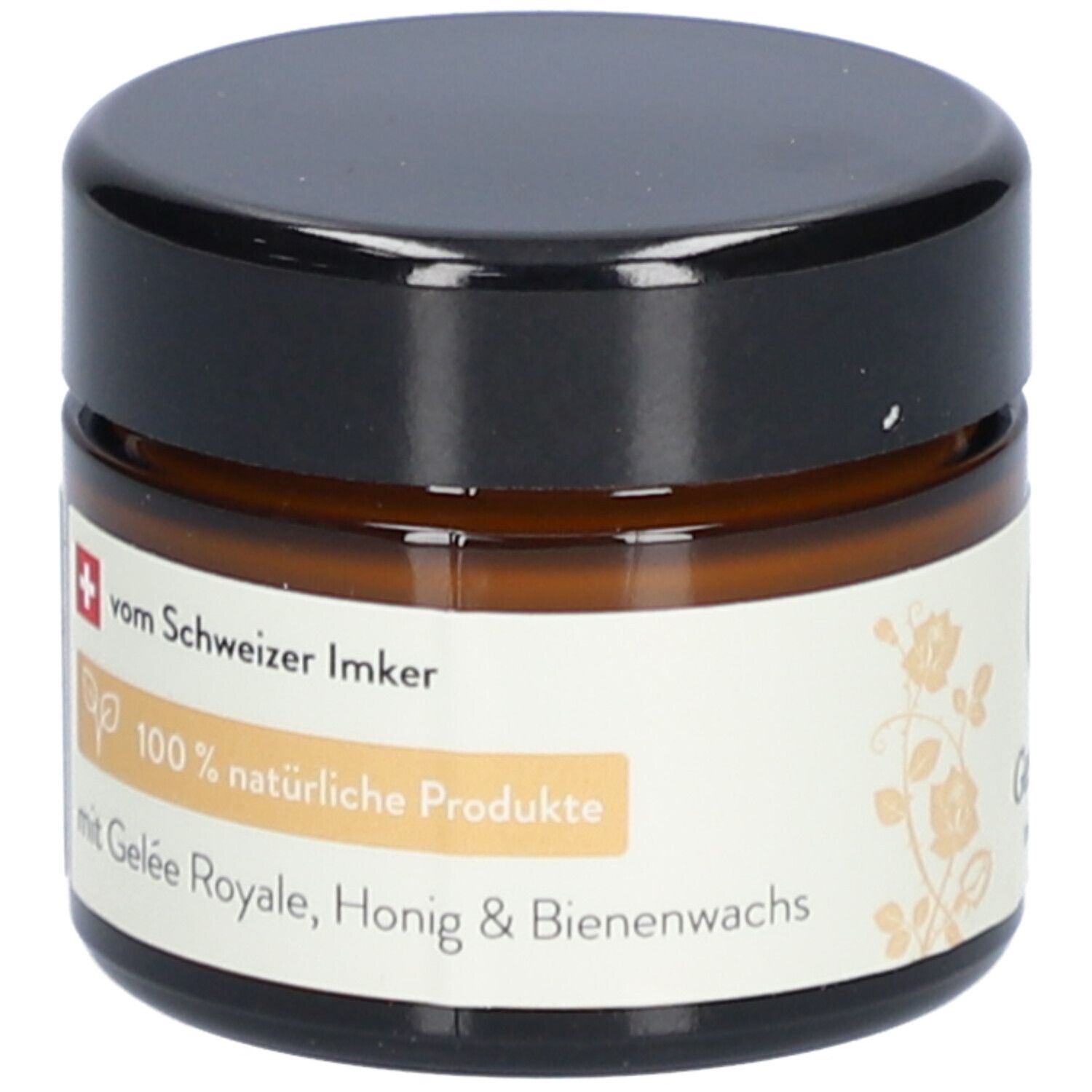 Braune Glasdose mit schwarzem Deckel. Etikett mit Text: 100% natürliche Produkte, mit Gelée Royale, Honig & Bienenwachs.