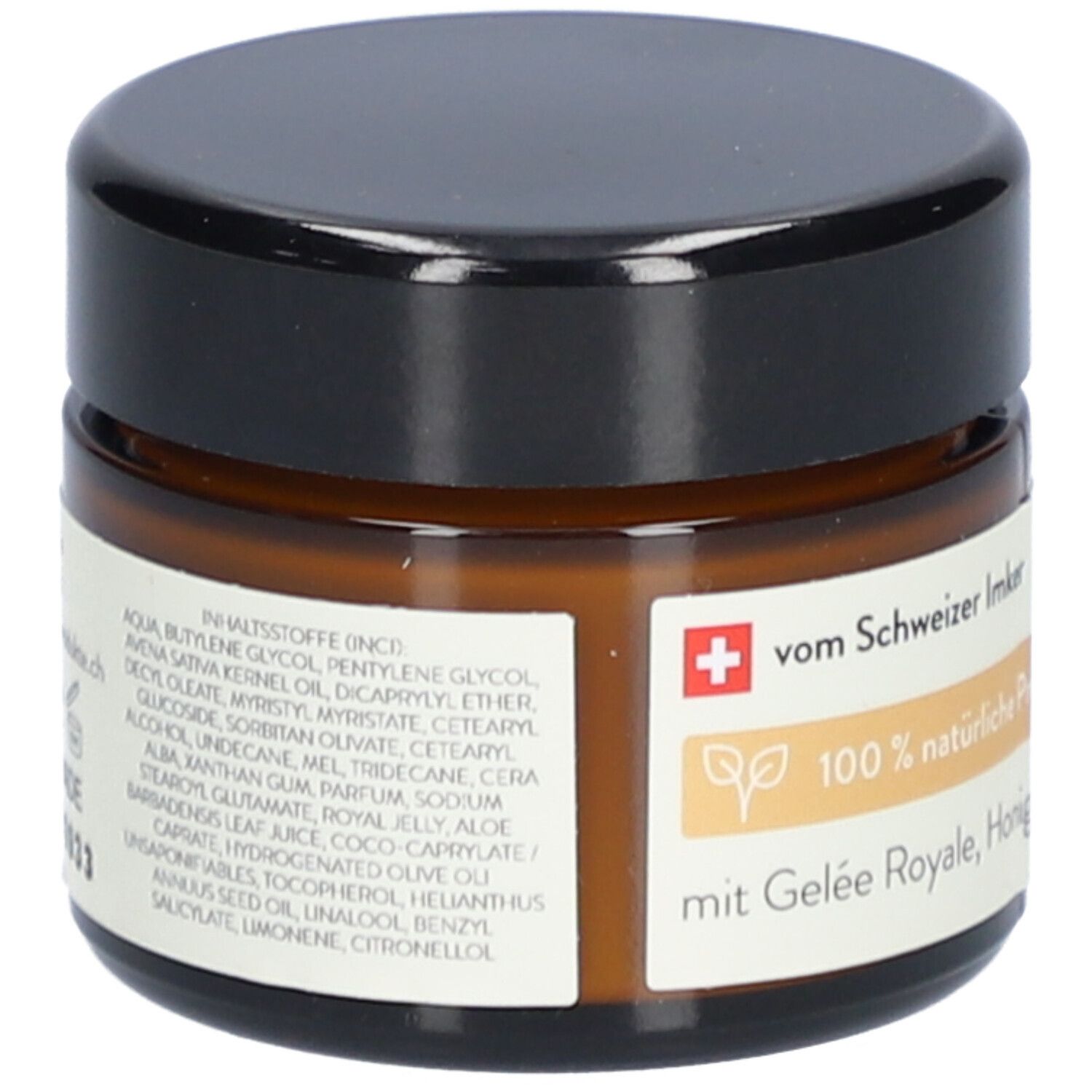 Braune Glasdose mit schwarzem Deckel. Etikett mit Inhaltsstoffen, Text: vom Schweizer Imker, 100% natürliche Produkte.