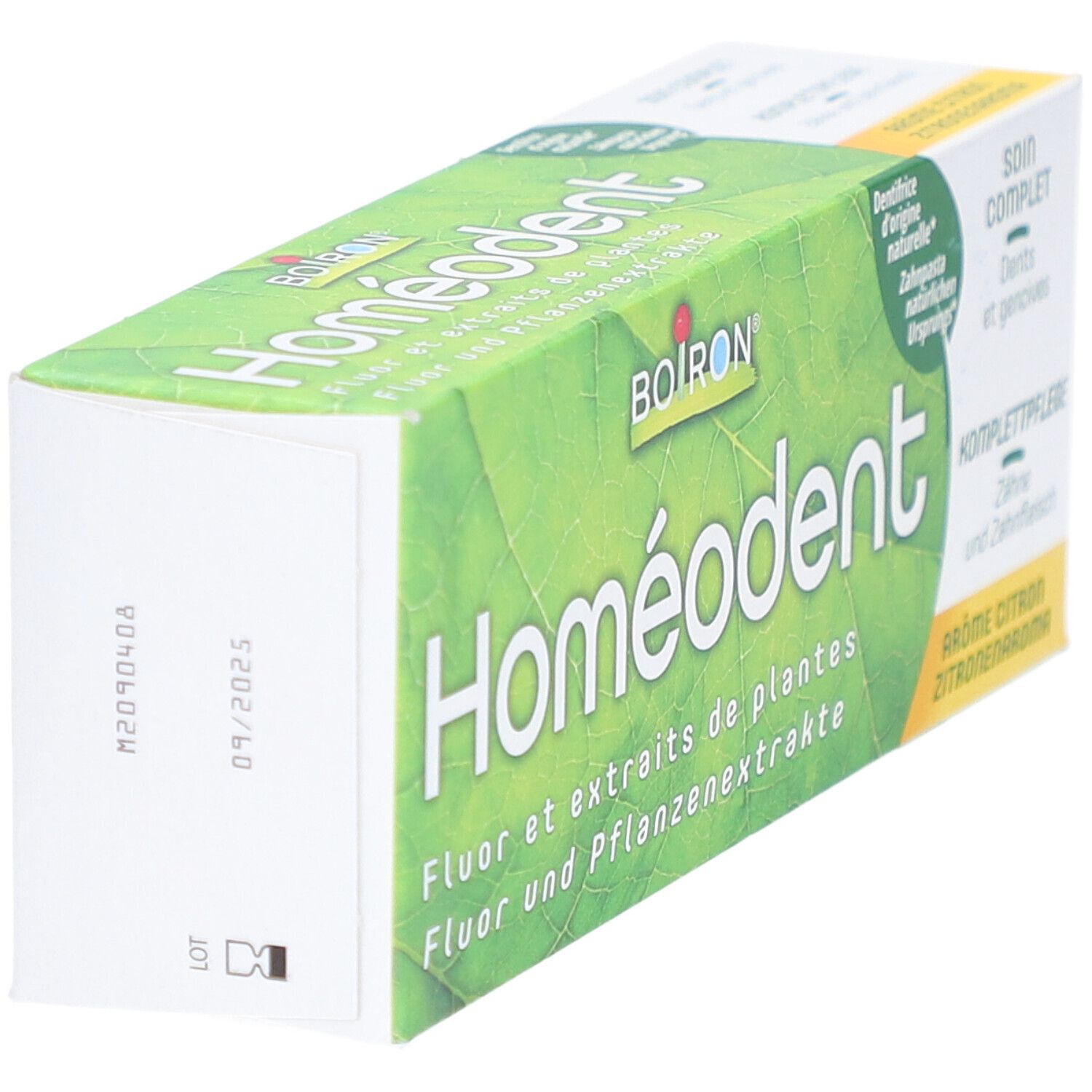Homeodent-Zahnpasta-Verpackung, schräg. Grün-weiß. Text: Homeodent, Fluor und Pflanzenextrakte, Zitrone.