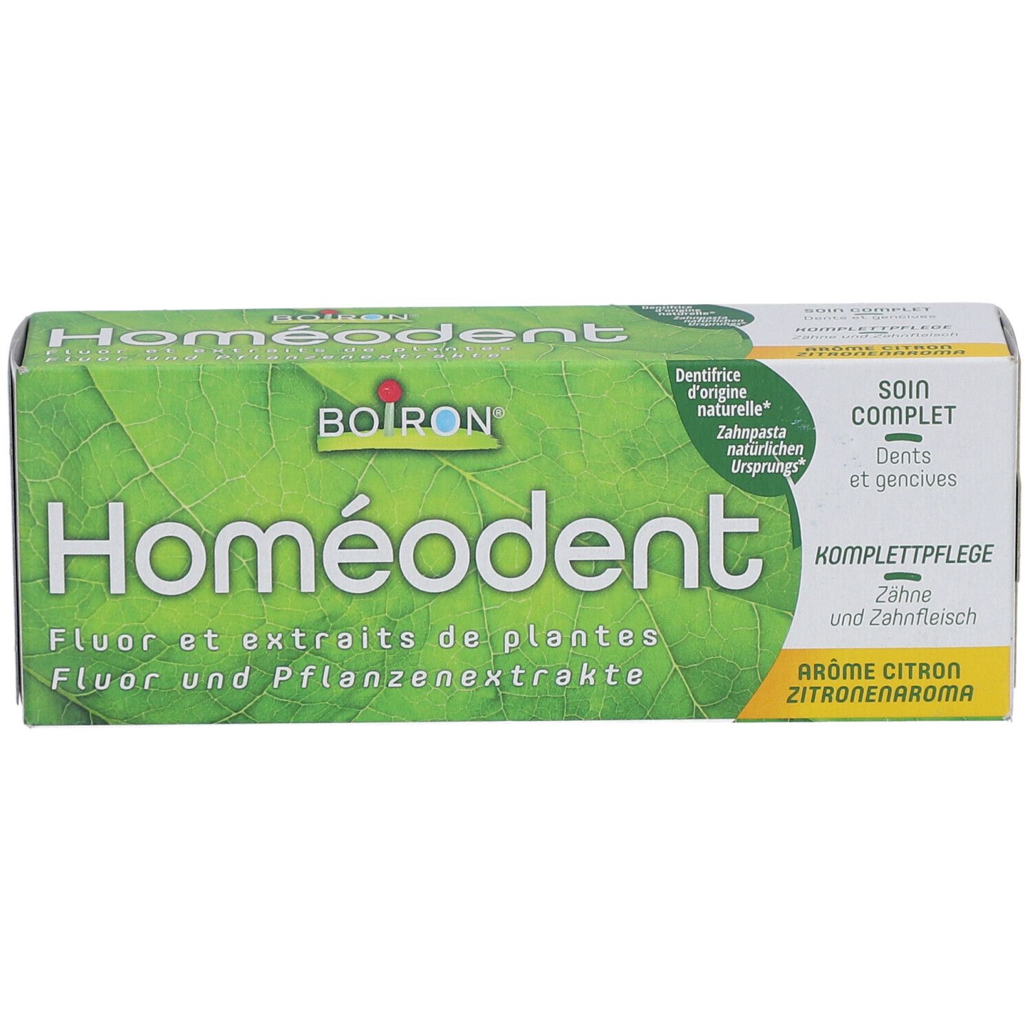 Homeodent-Zahnpasta-Verpackung. Text: Homeodent, Fluor und Pflanzenextrakte, Zitrone, 75 ml.