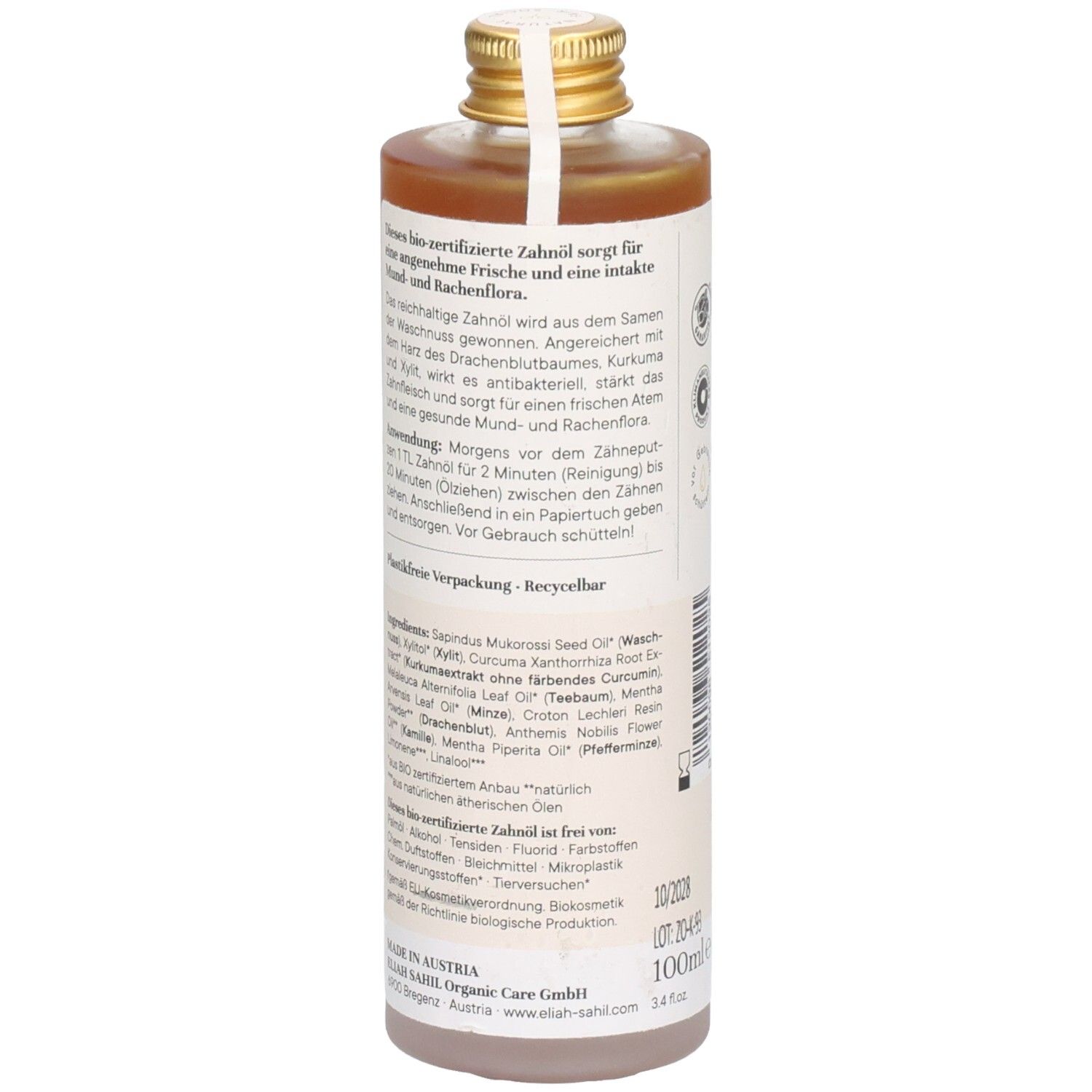 Rückseite einer Flasche mit brauner Flüssigkeit. Etikett mit Text über Inhaltsstoffe und Anwendung. Goldener Deckel.