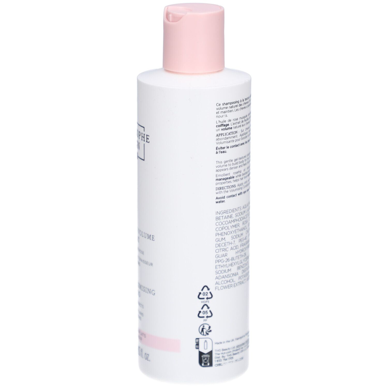 Rückseite der Shampoo-Flasche. Text und Symbole sind sichtbar. Weiße Flasche mit rosa Details.