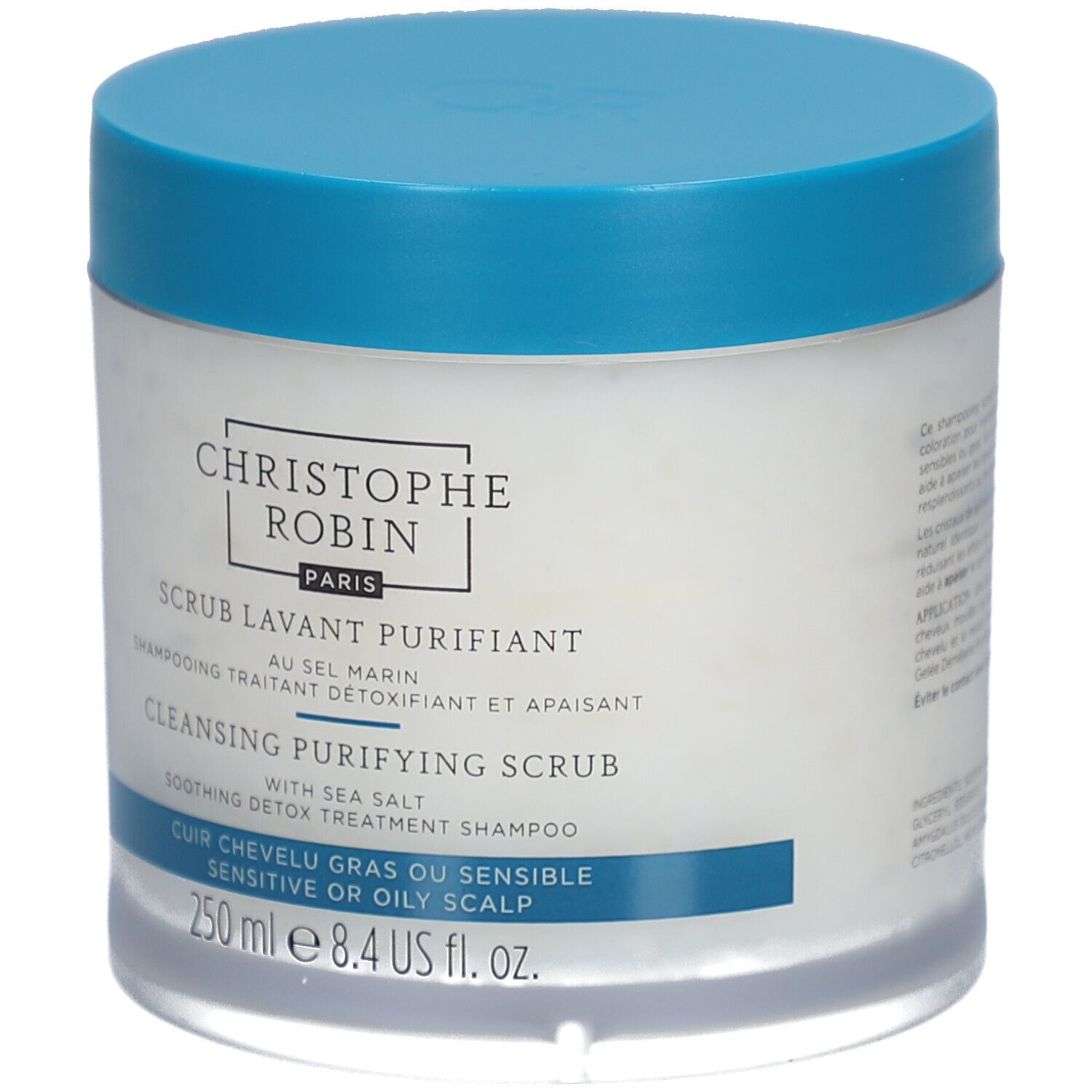 Runde Dose mit blauem Deckel. Aufschrift: CHRISTOPHE ROBIN PARIS, SCRUB LAVANT PURIFIANT, CLEANSING PURIFYING SCRUB, 250 ml.