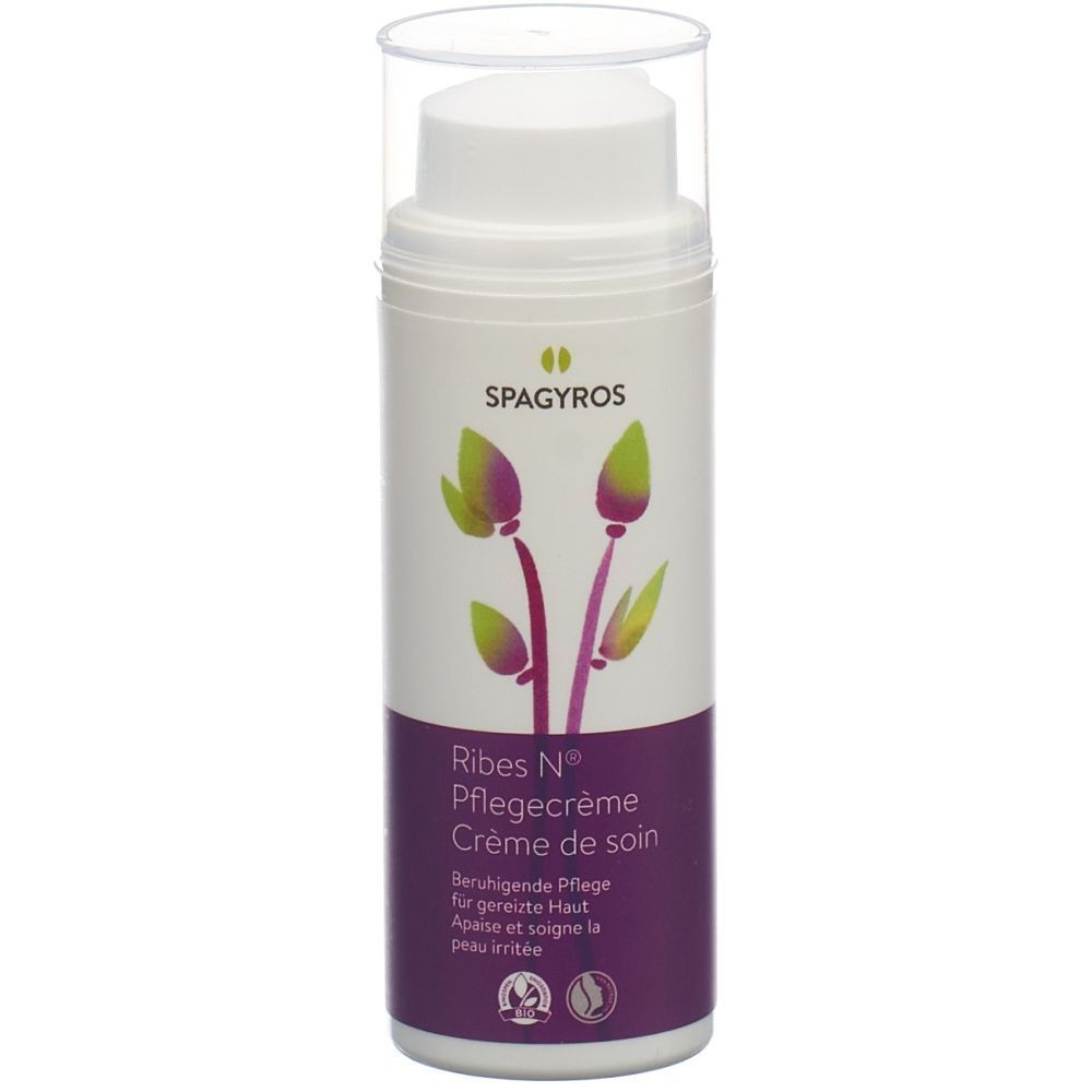 Creme-Spender mit SPAGYROS-Logo und Produktnamen Ribes N® Pflegecreme. Lila-weiße Verpackung mit floralem Design.