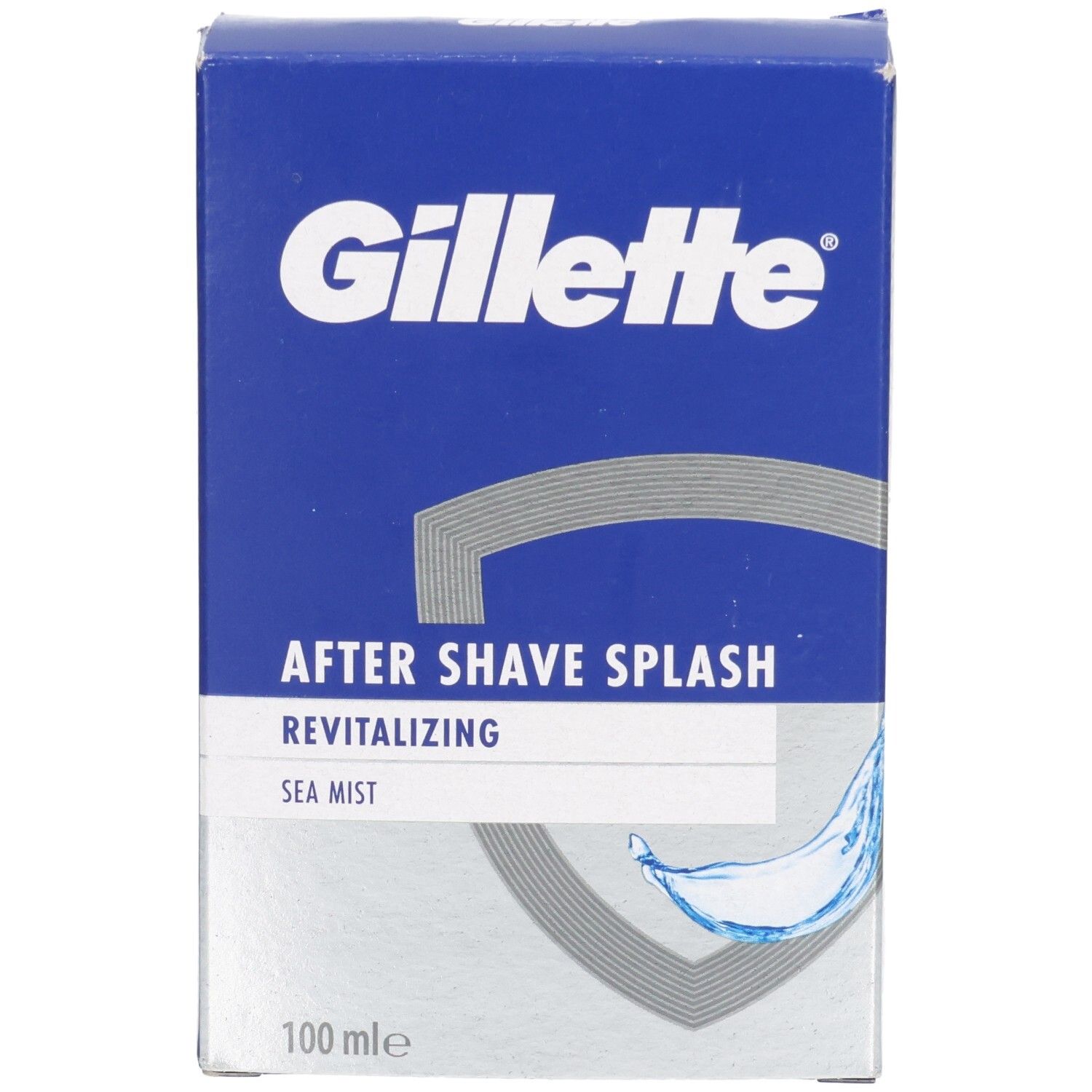 Blaue Schachtel mit Gillette-Logo. "AFTER SHAVE SPLASH" und "Sea Mist" auf silbernem Feld. Graue Wellen-Grafik. "100 mle".
