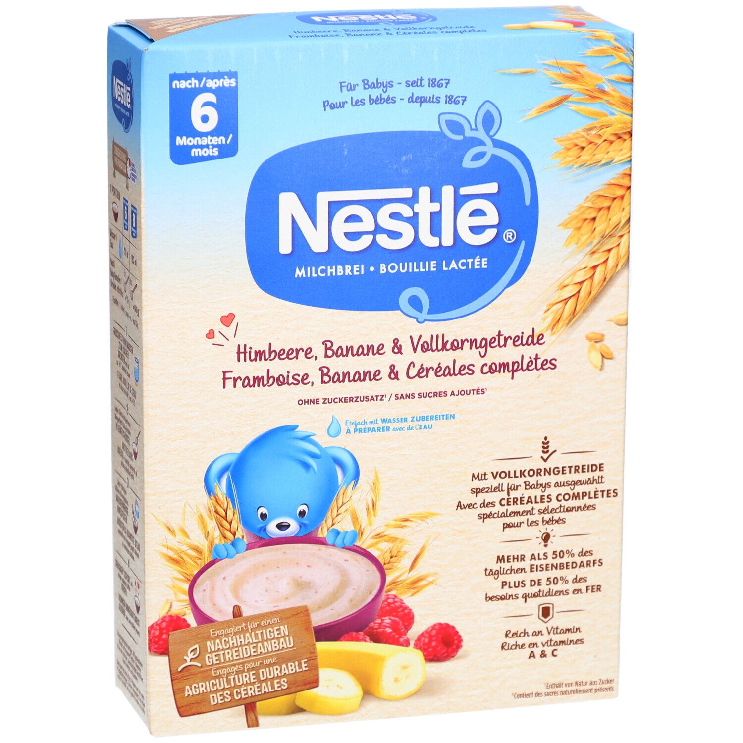 Nestlé Milchbrei-Packung. Blaue Verpackung mit Produktnamen und Illustrationen von Himbeeren, Bananen und Getreide. Altersempfehlung: 6M+.
