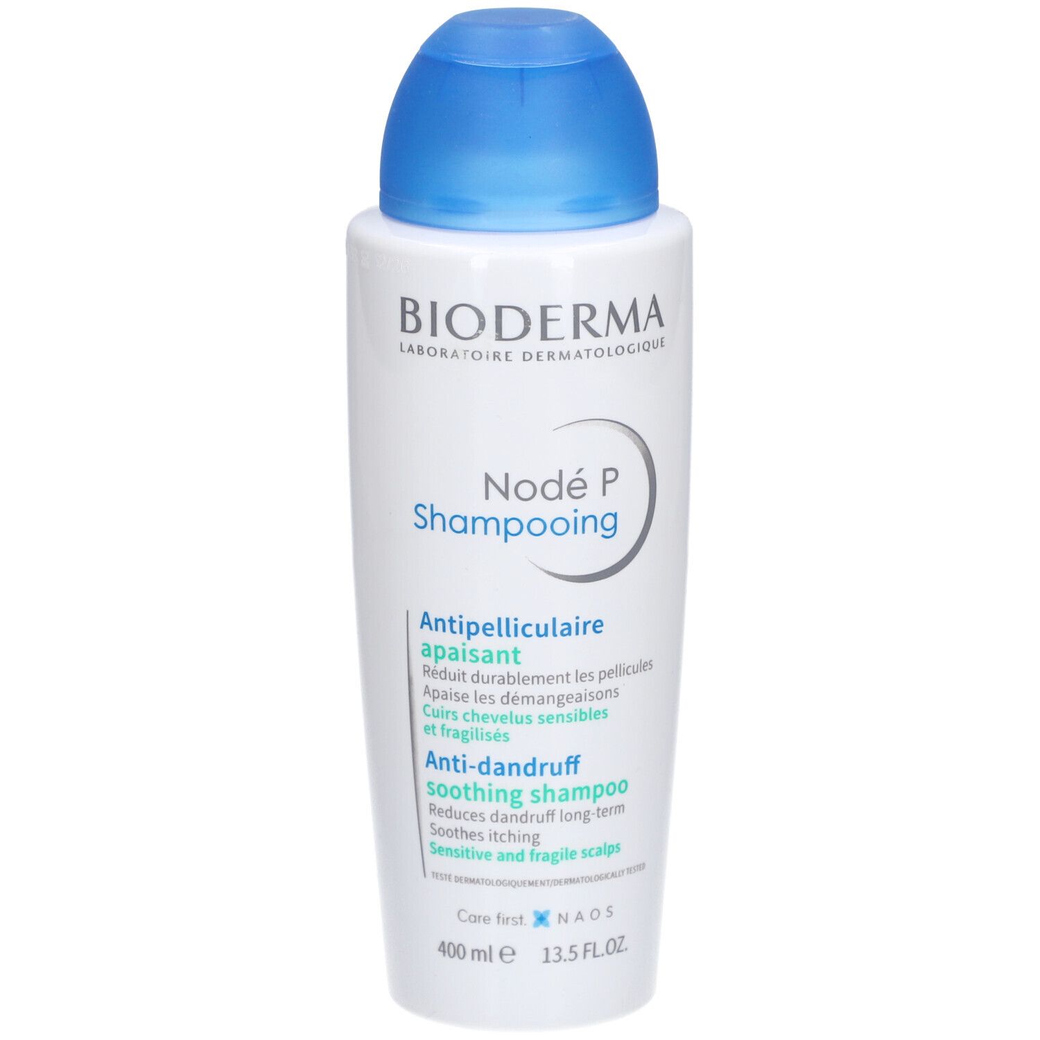 Bioderma Nodé P Shampooing, weiße Flasche mit blauem Deckel. Produktetikett mit Text in mehreren Sprachen.