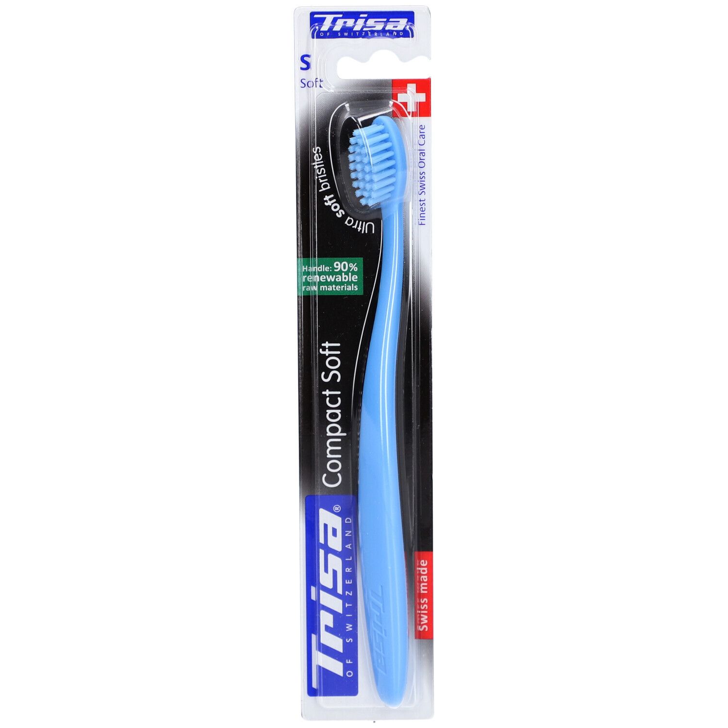 Brosse à dents bleue claire avec tête de brosse bleue, emballée. Marque Trisa, "Compact Soft" et "Swiss made" visibles.