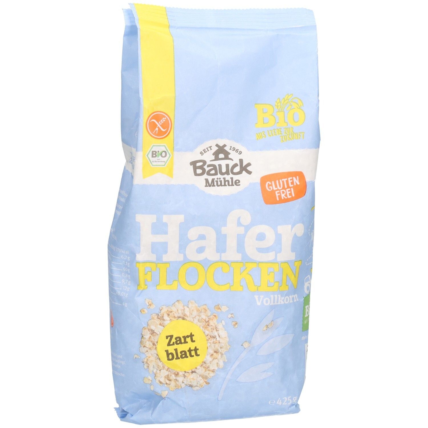 Hellblaue Tüte mit Haferflocken. Aufdruck: Bauck Mühle, Haferflocken Vollkorn Zartblatt glutenfrei. Bio-Siegel und Glutenfrei-Logo.