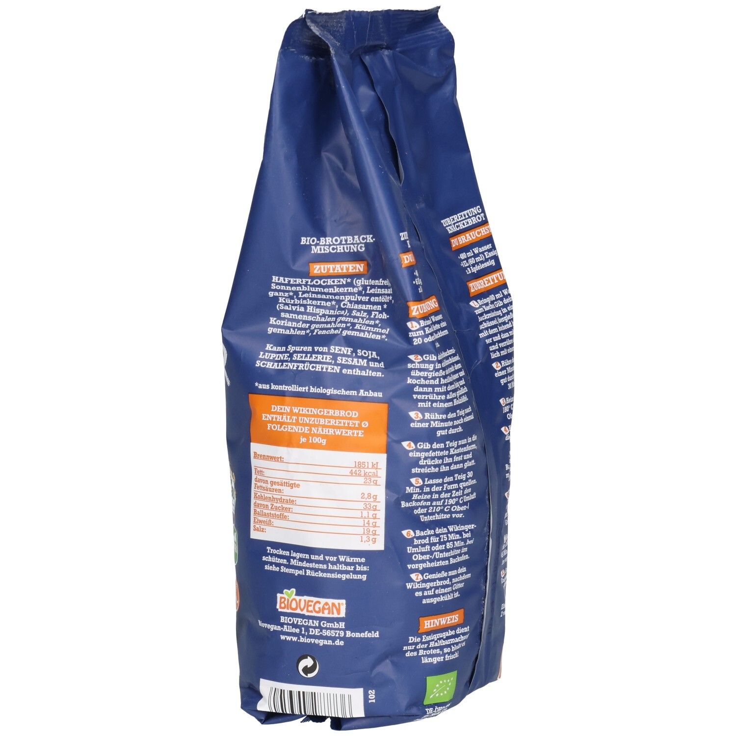 Blaue Verpackung, Rückseite. Nährwerttabelle und Zutatenliste. Biovegan-Logo. Glutenfrei-Symbol. Text und Illustrationen.