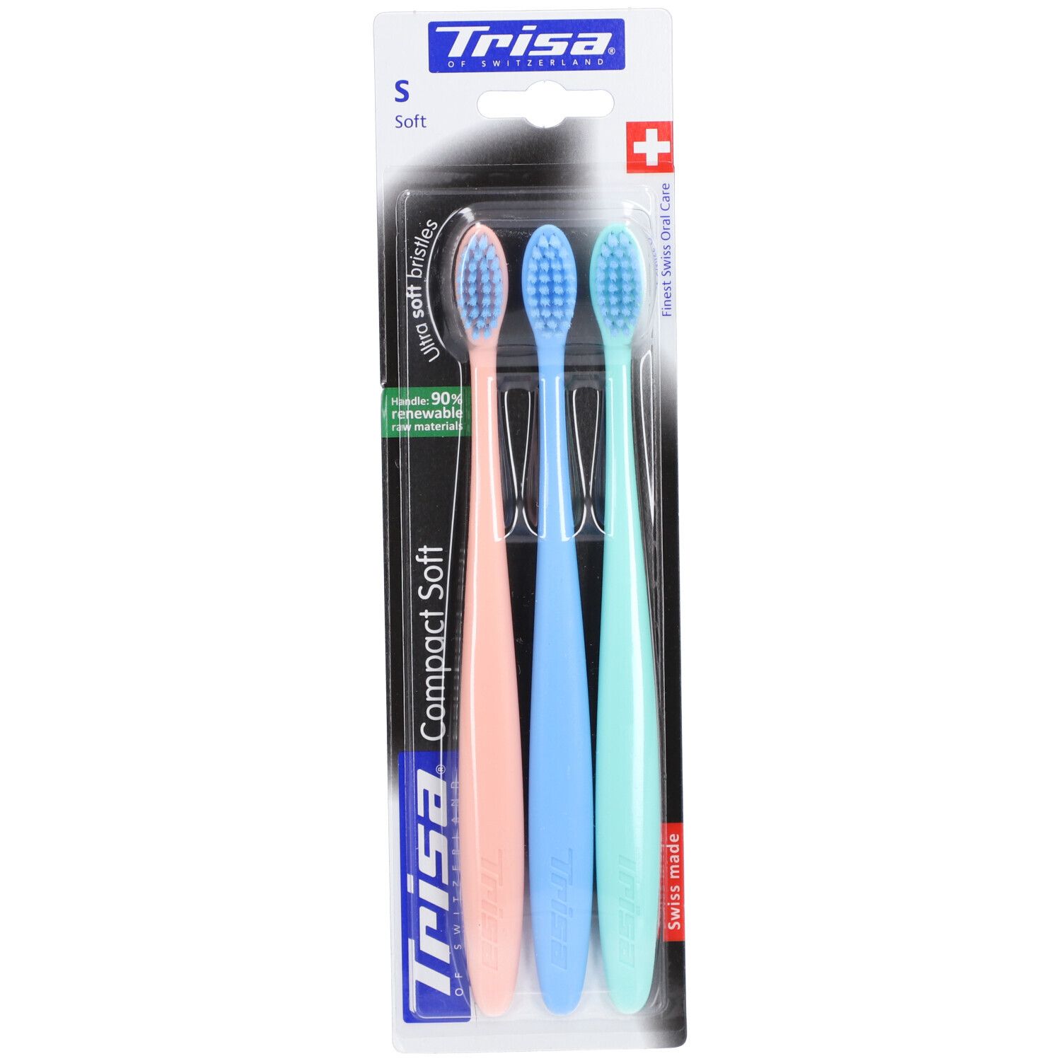Drei Zahnbürsten Trisa Compact Soft, weich, in Pastellfarben. Auf Blisterverpackung mit Schweizer Kreuz und Logo.