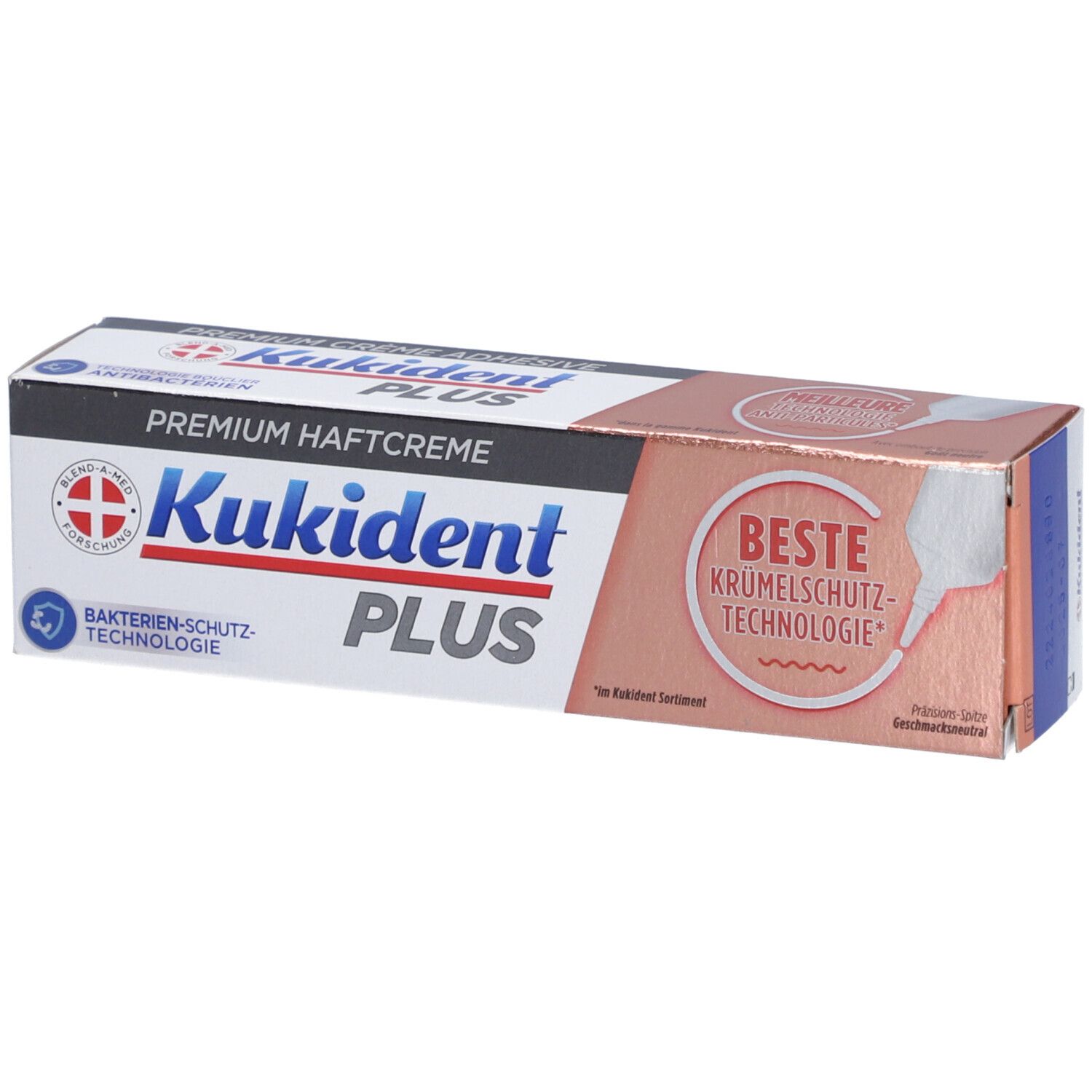 Boîte de crème adhésive. Inscription: Kukident PLUS, Premium Haftcreme, Technologie de protection antibactérienne. Meilleure technologie anti-miettes.