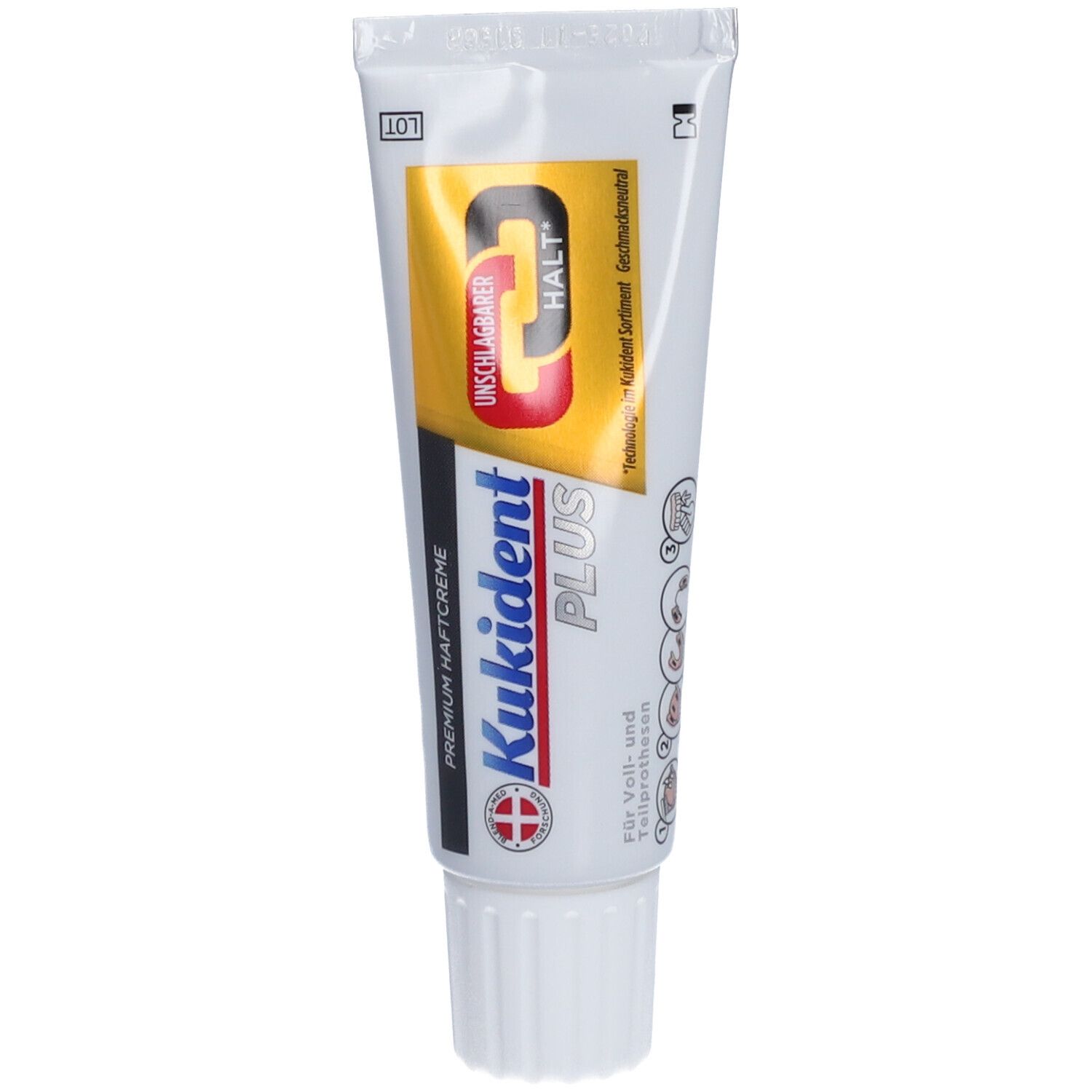 Zahnprothesen-Haftcreme-Tube. Weiß, mit blauer, gelber und roter Beschriftung. Produktname und Logo deutlich sichtbar.