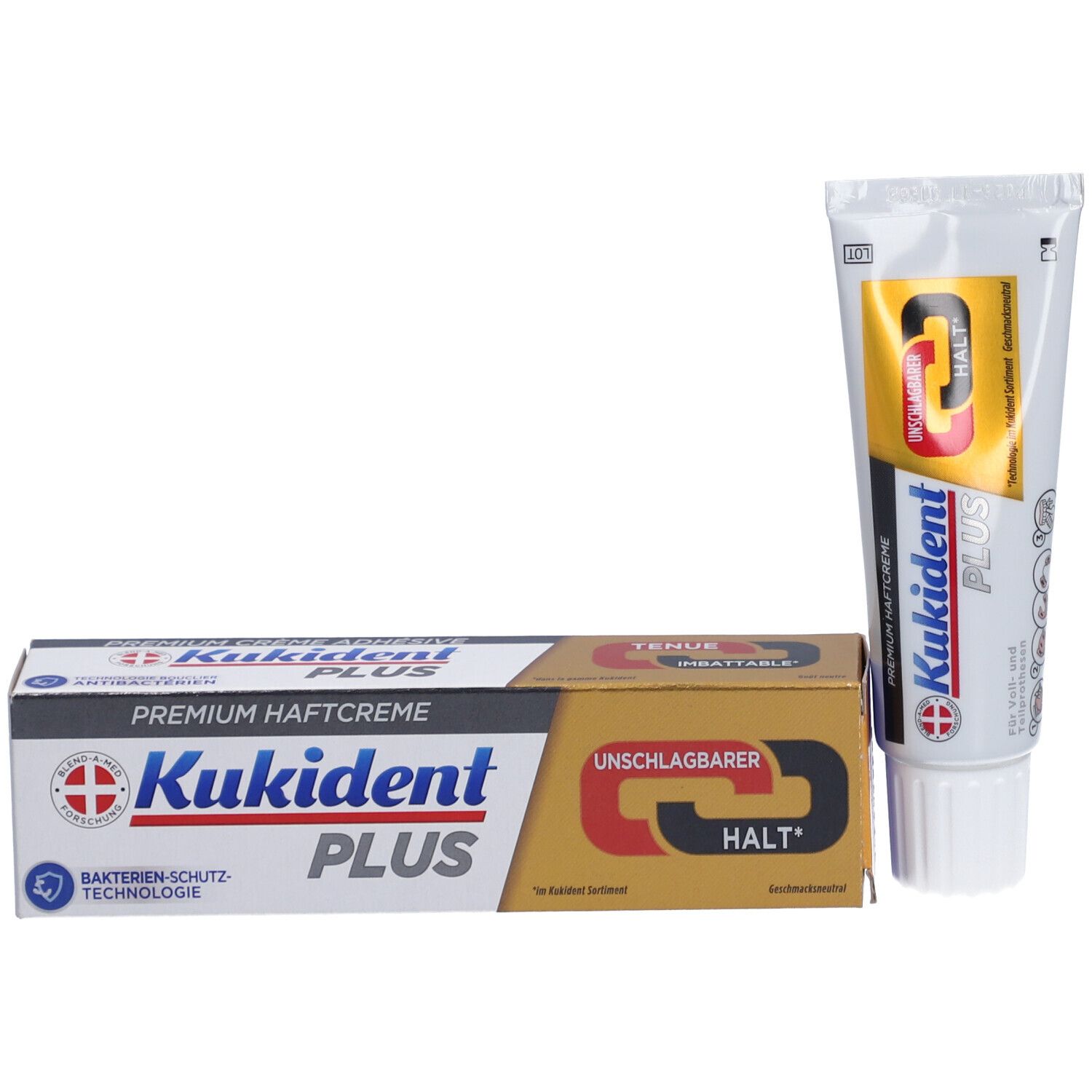 Produktverpackung und Tube. Karton und Tube mit Produktnamen und Logo. Goldfarbener Karton mit roter und schwarzer Schrift.