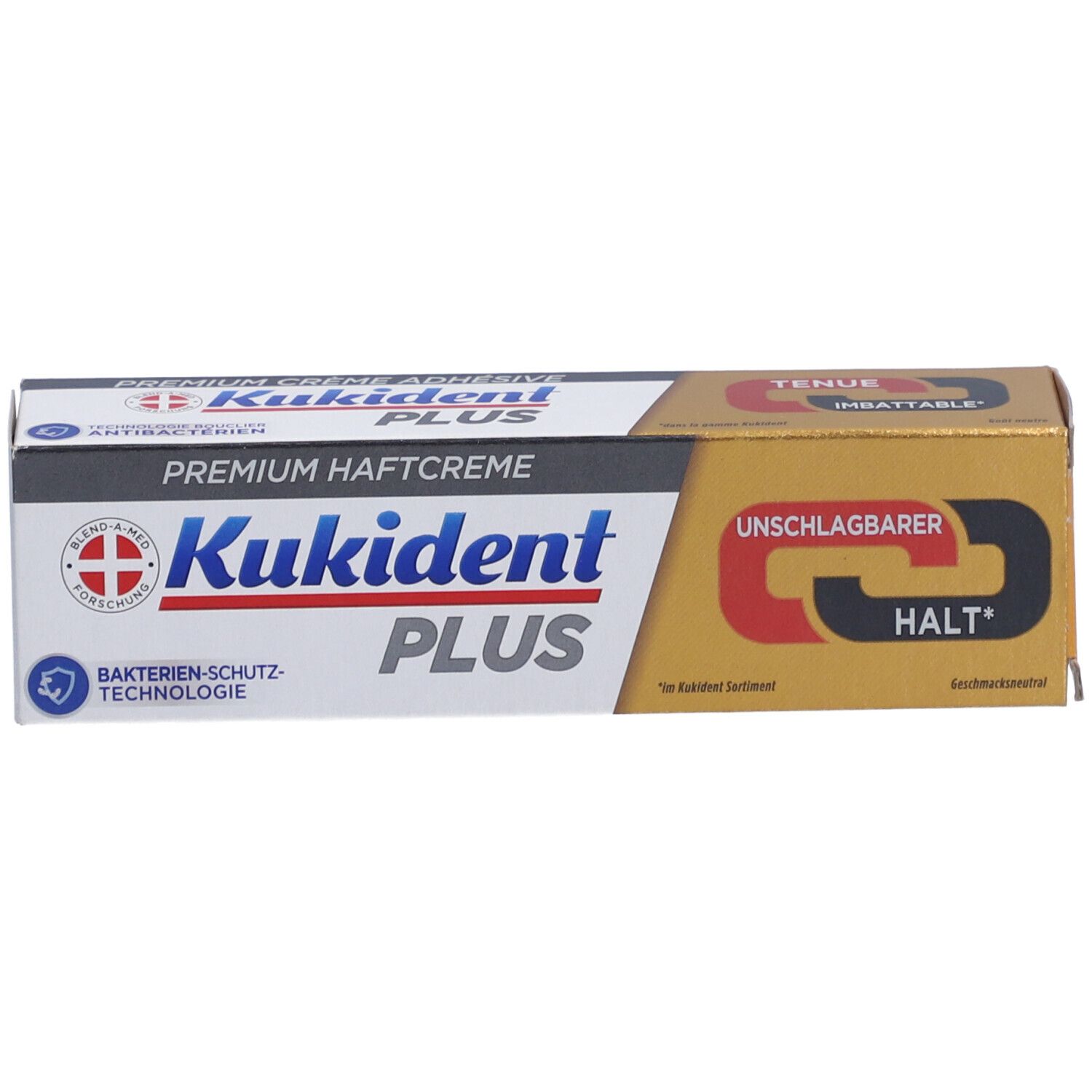 Produktverpackung. Goldfarbener Karton mit Produktnamen, Logo und Text. Schwarze und rote Schrift.