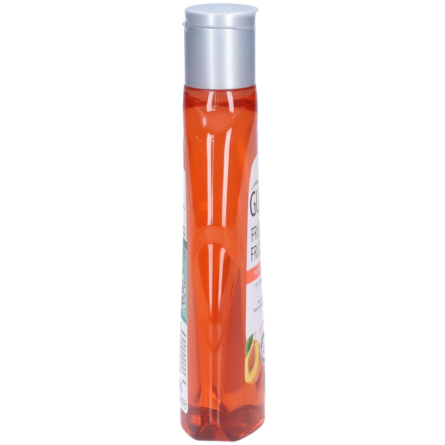 Schmale, transparente Flasche mit orangefarbenem Shampoo. Silberner Deckel. Aufschrift auf der Seite.
