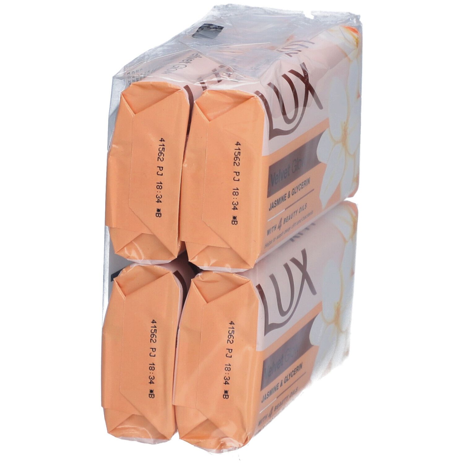 Verpackung mit vier Seifenstücken. Rückseite der Seifen in orangefarbener Folie sichtbar.