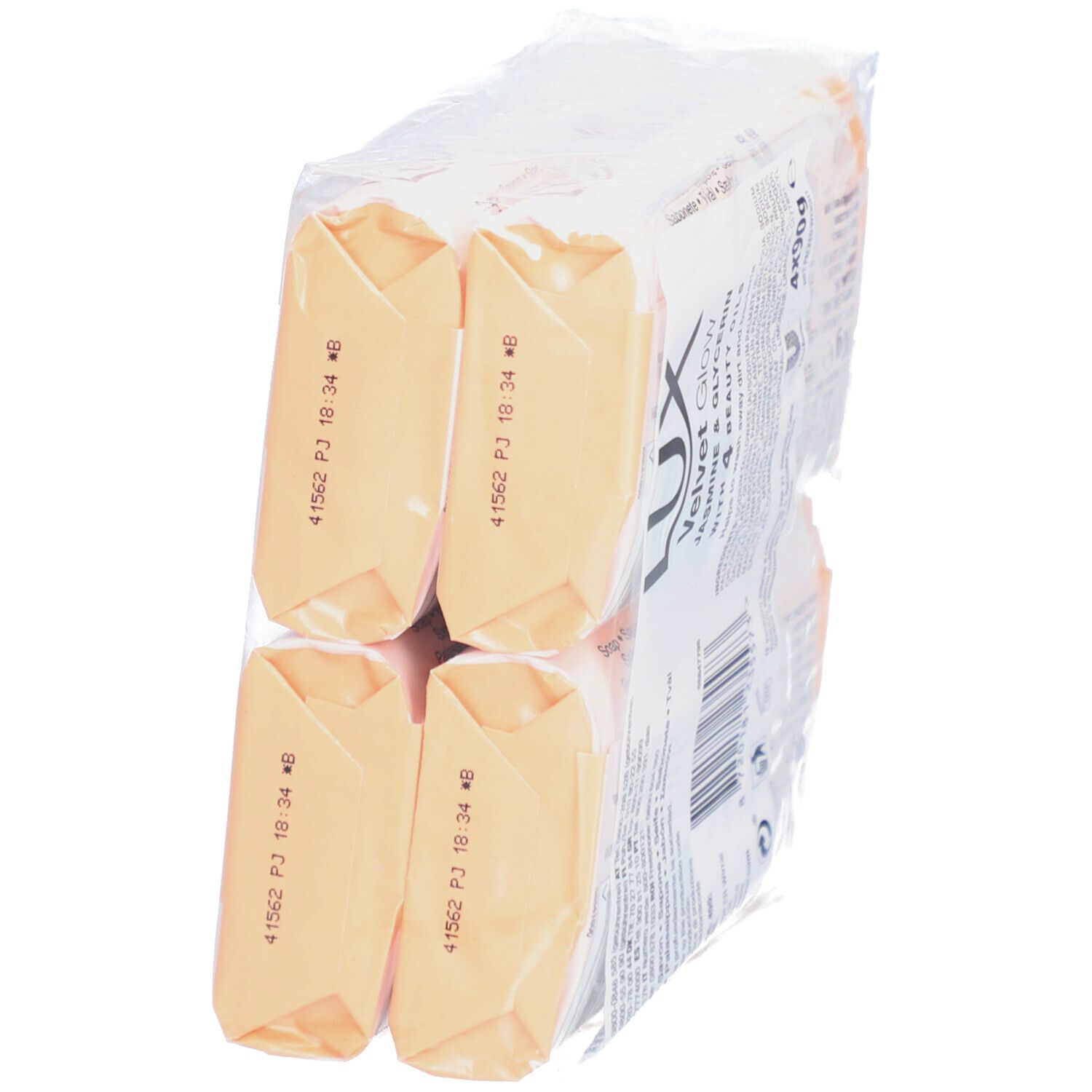 Verpackung mit vier Seifenstücken. Rückseite der Seifen in orangefarbener Folie sichtbar.