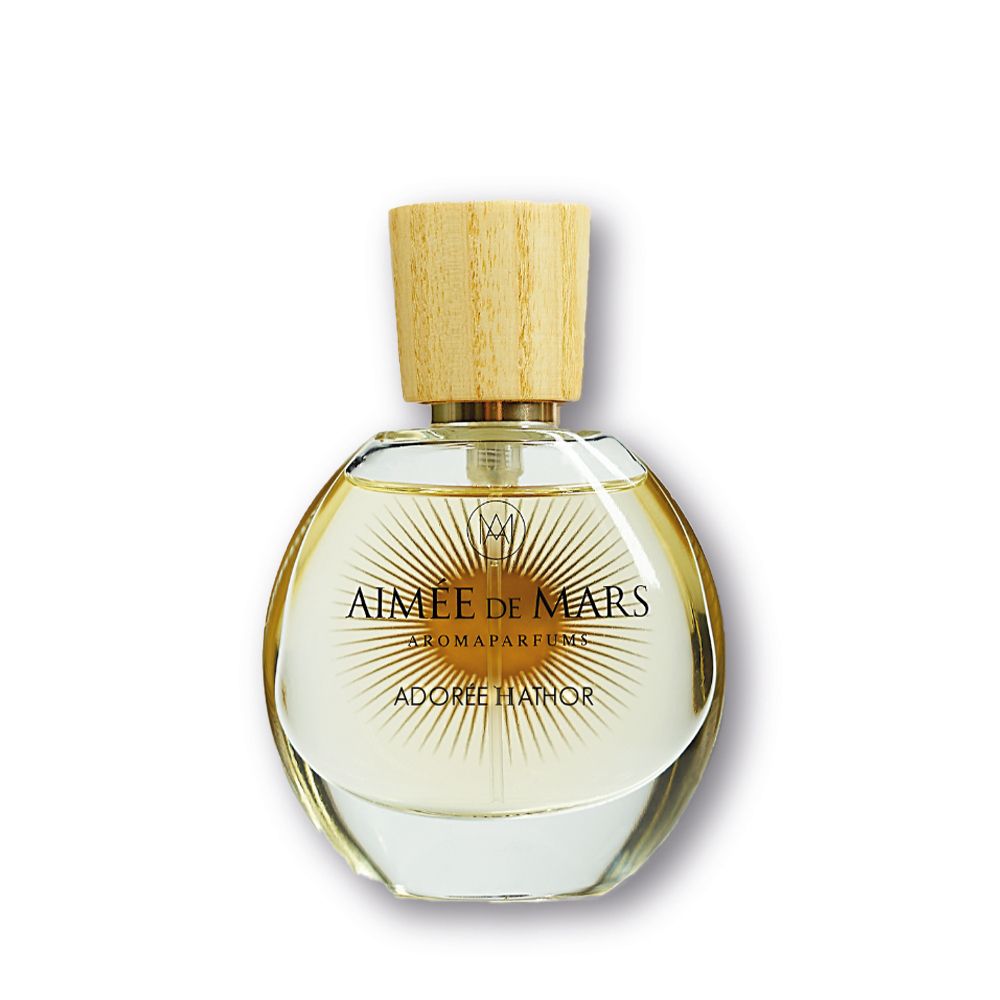 Runder Glasflakon mit Holzverschluss. Aufschrift: AIMÉE DE MARS, ADORÉE HATHOR. Aromaparfum.