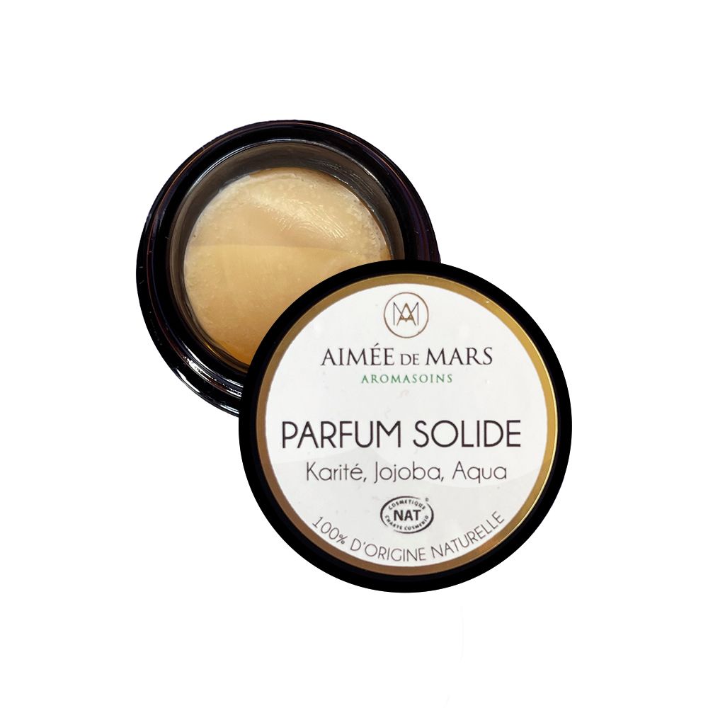 Offenes Glas mit schwarzem Deckel. Auf dem Deckel steht "Parfum Solide". Aufschrift: Karité, Jojoba, Aqua.