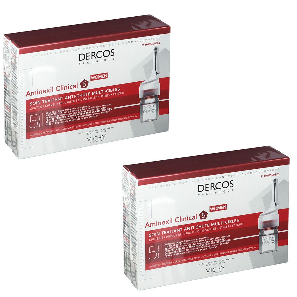 Deux boîtes de VICHY Dercos Aminexil Clinical 5. Boîtes blanches avec dessus rouge. Inscription: Dercos, Aminexil Clinical 5, Women. Ampoule représentée.